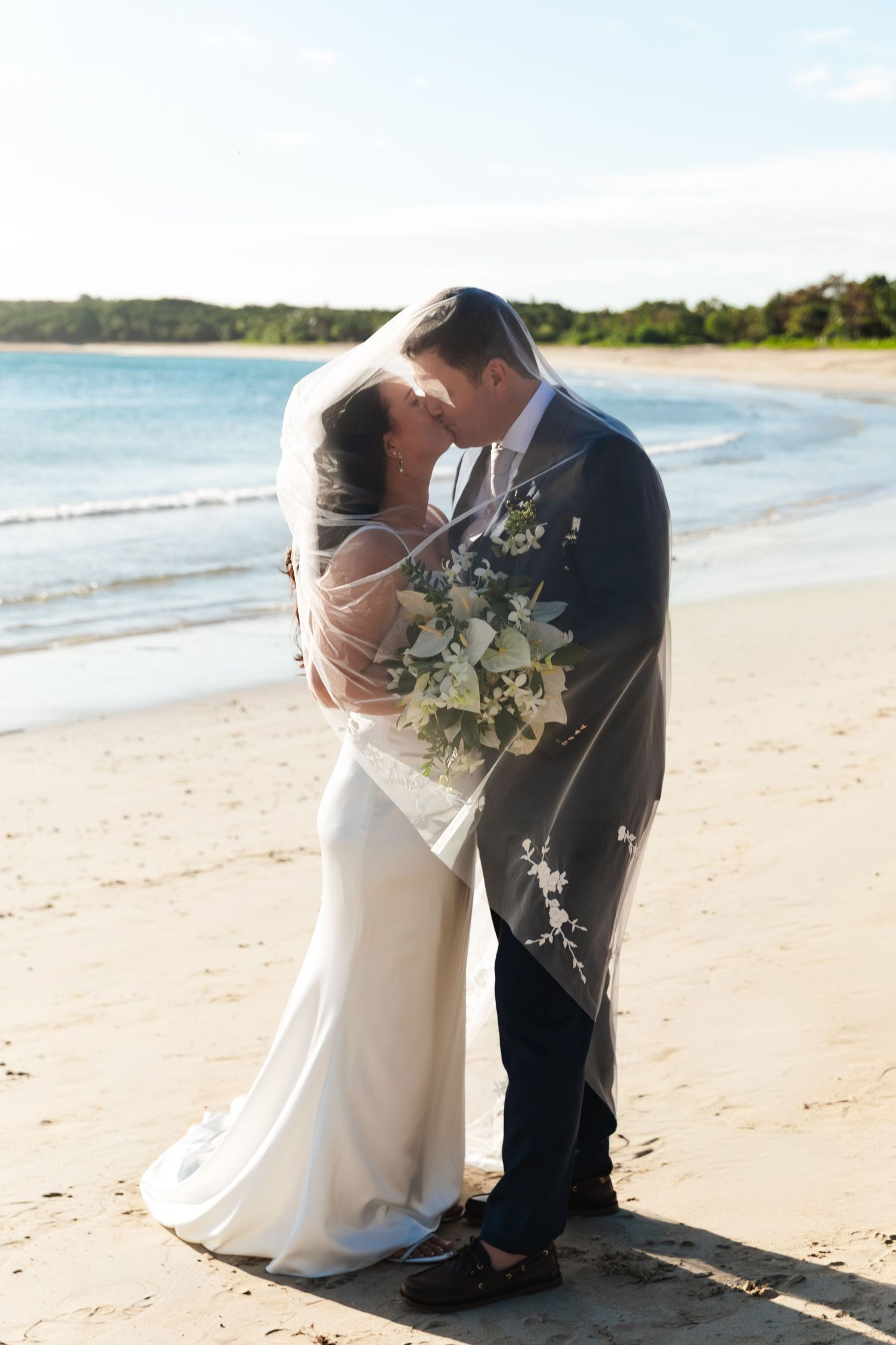 Fiji destination wedding photography capturing a couple celebrating by the ocean