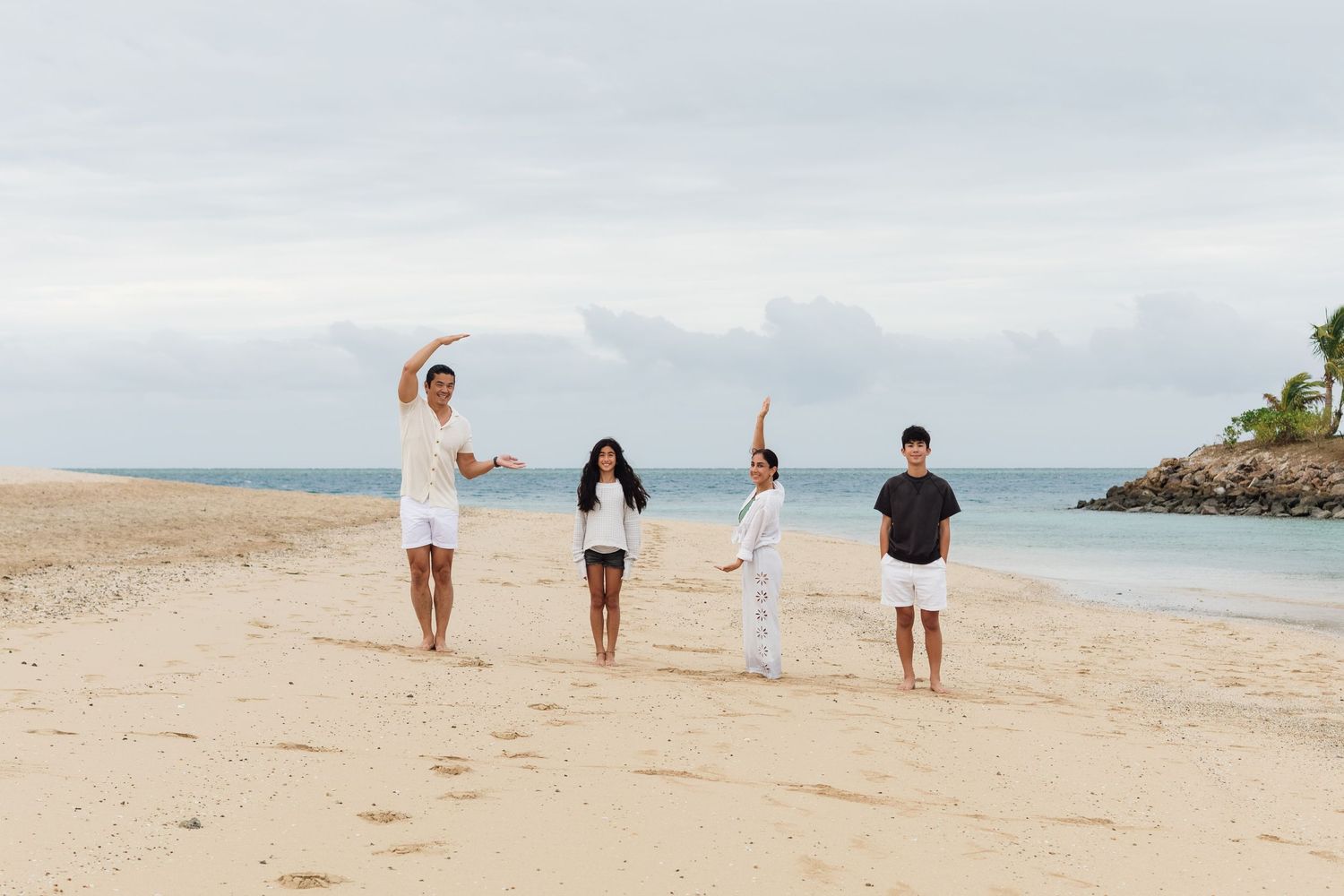 Happy family enjoying a Fiji beach photography session in Fiji on beach