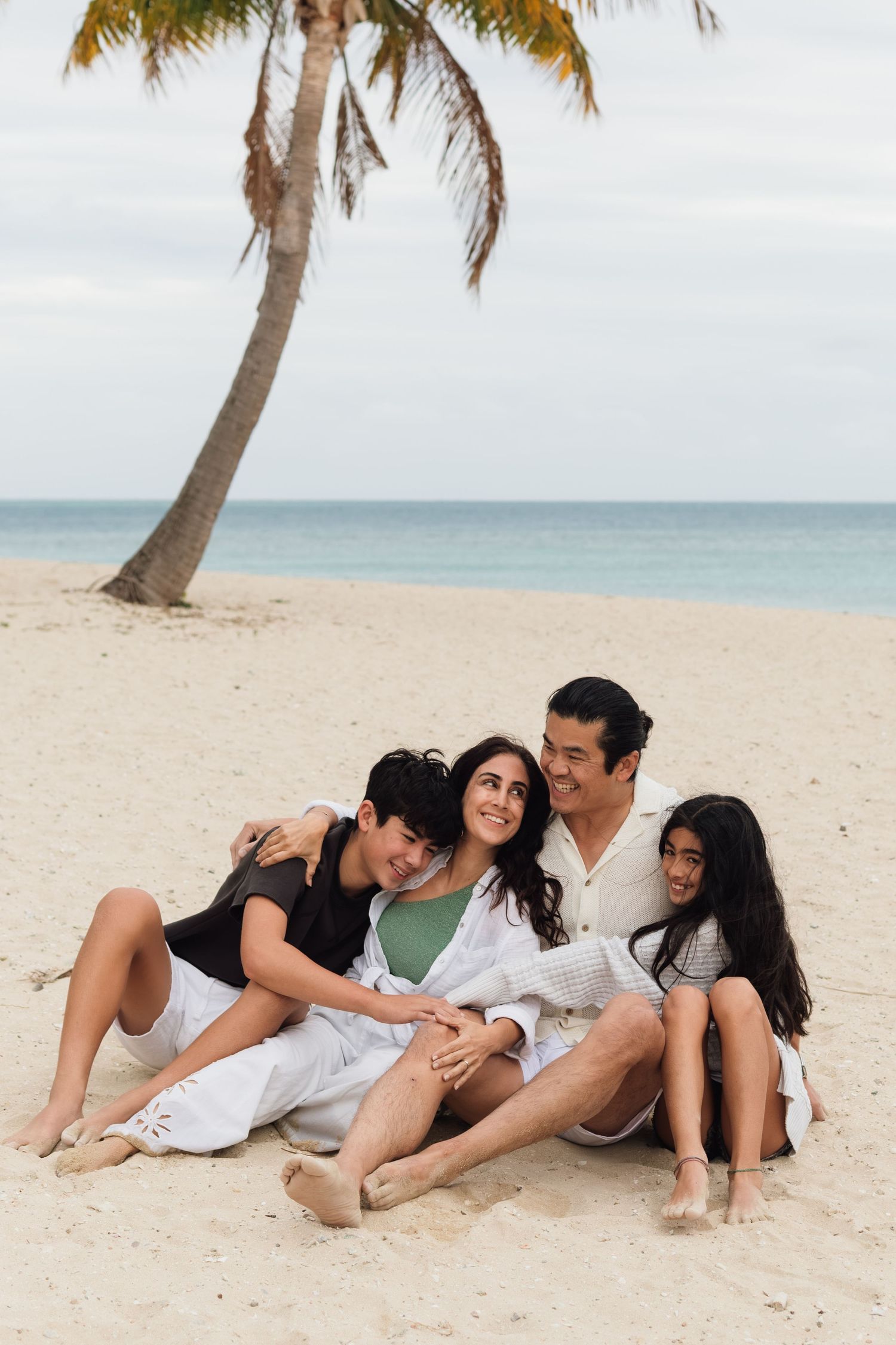 Happy family enjoying a Fiji beach photography session in Fiji on beach