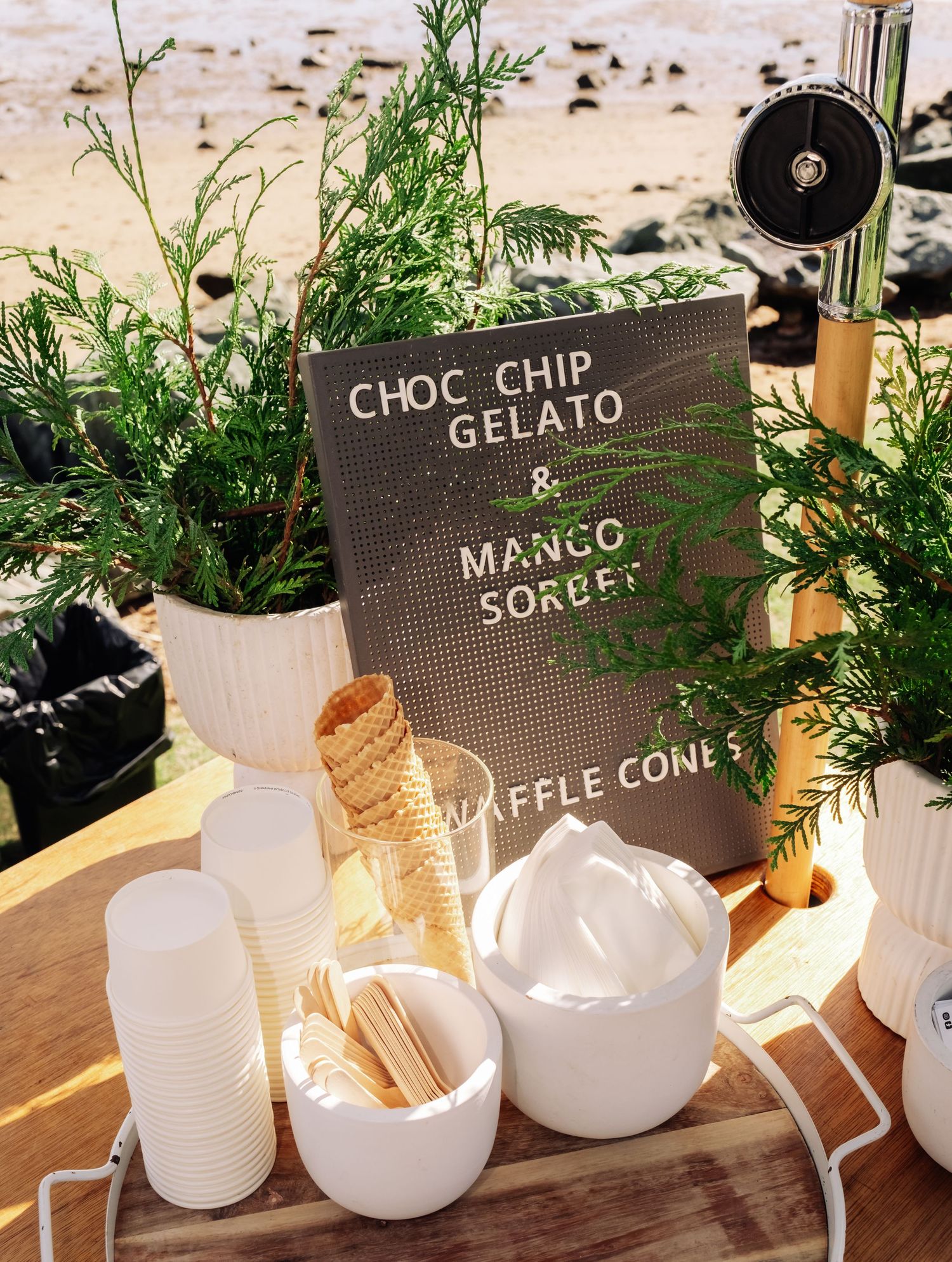 Wedding dessert station with choc chip gelato, mango sorbet, and waffle cones display.