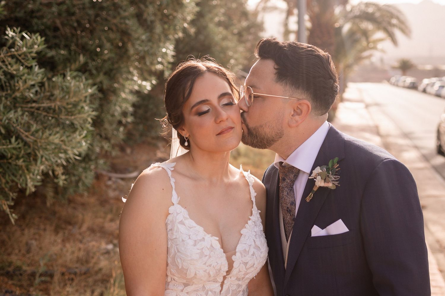 A tender moment between newlyweds during golden hour.