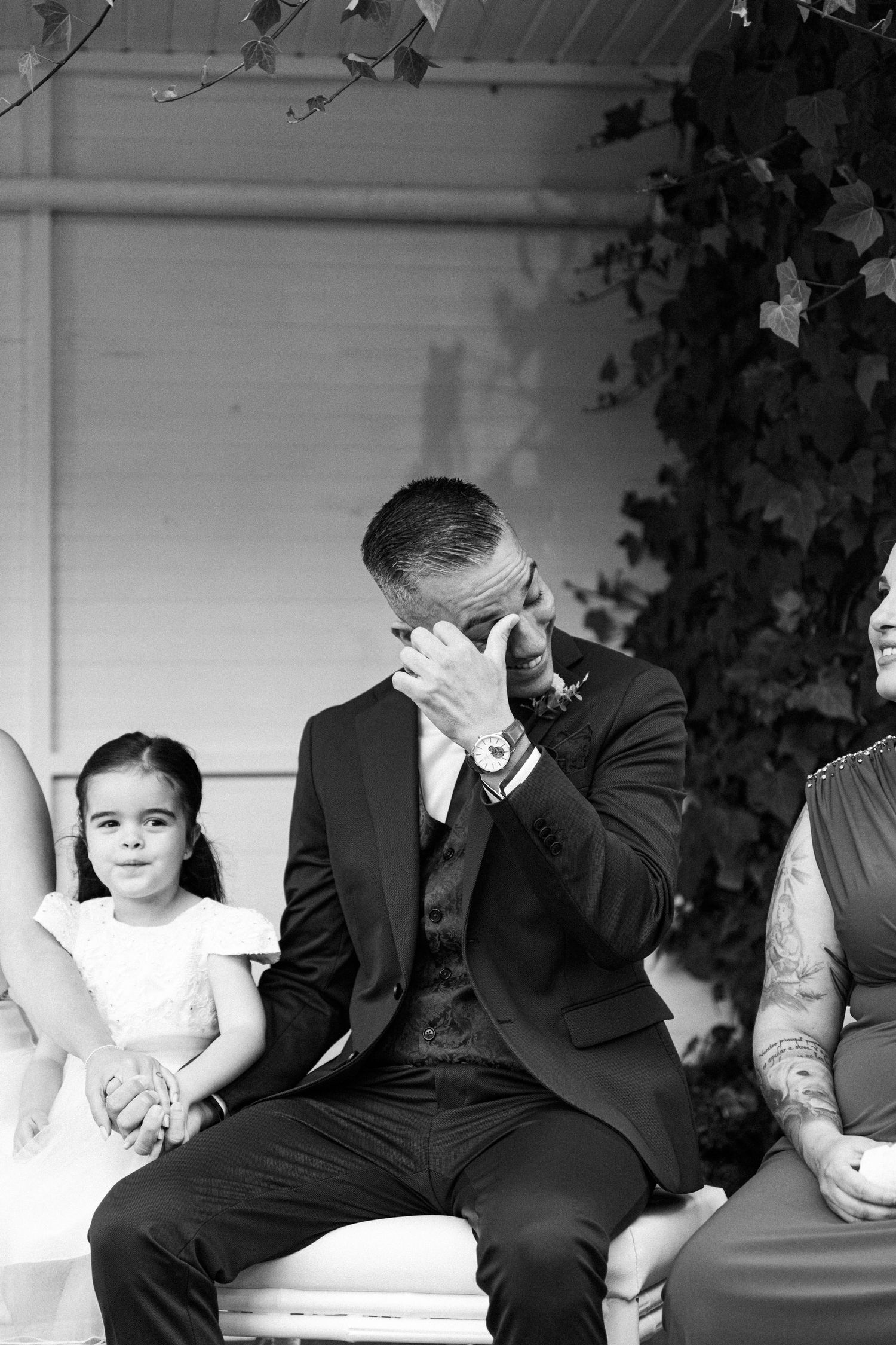 Black and white photo showing emotional reactions during a wedding ceremony.