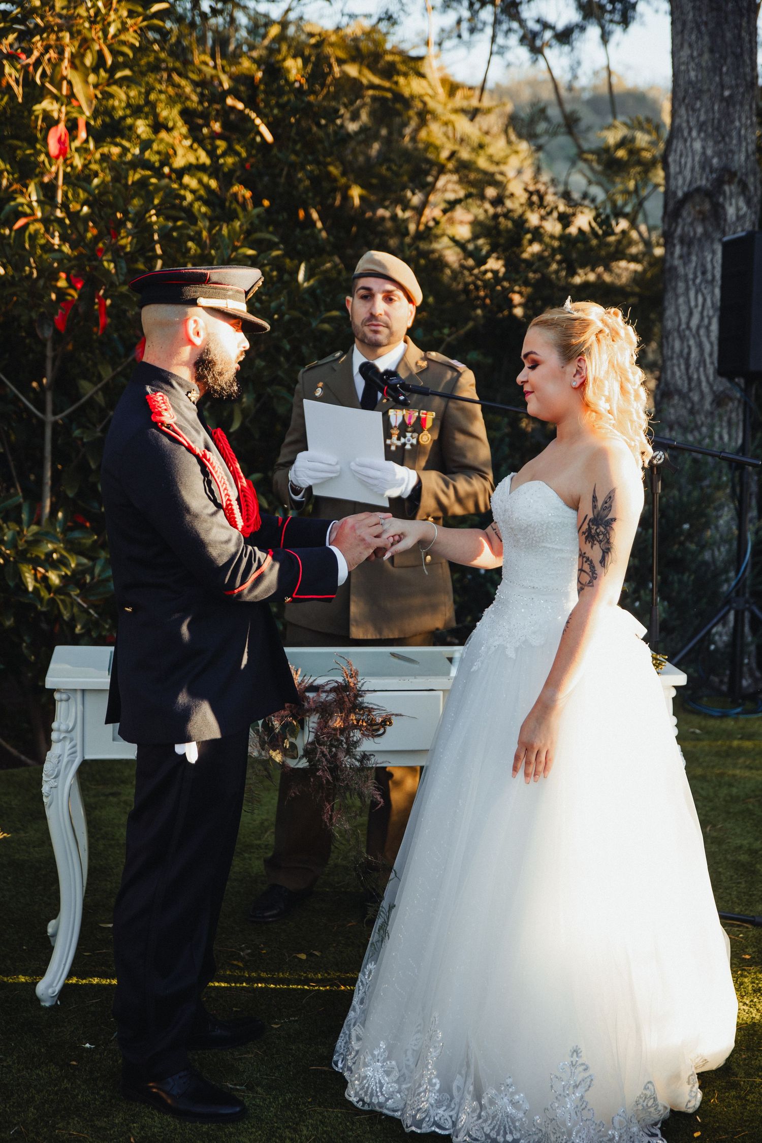 Wedding celebration in garden setting with white piano and formal attire.