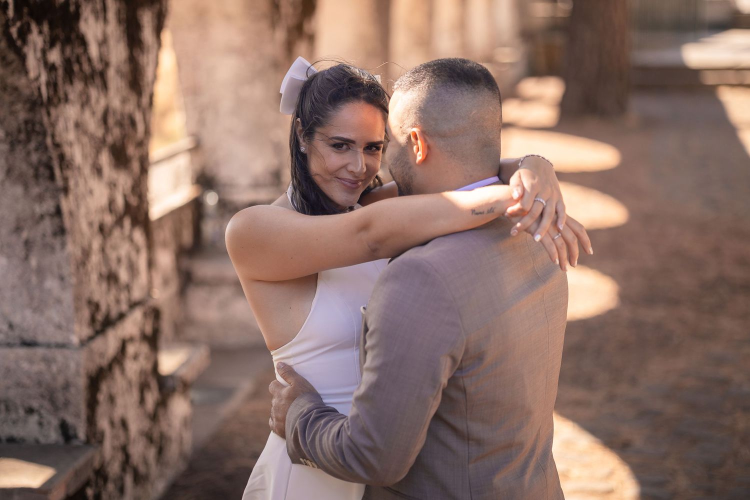 A couple embraces during a romantic sunset dance outdoors.