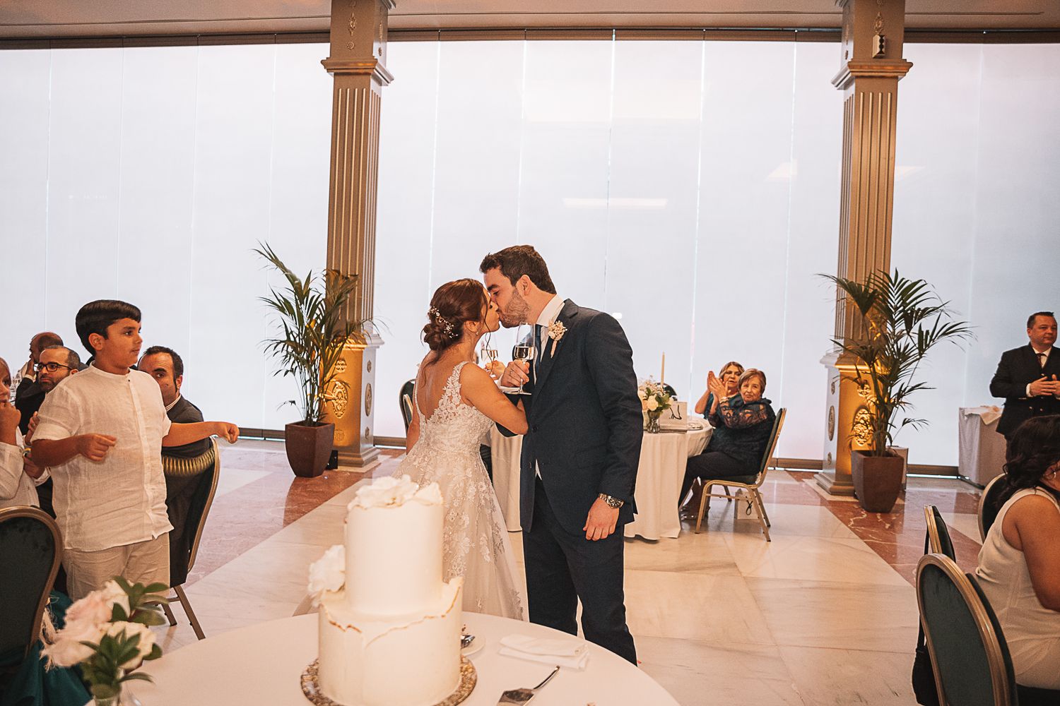 Wedding venue with wooden columns and natural lighting creating an airy atmosphere.