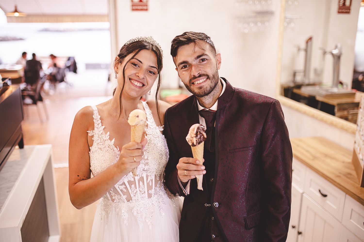Wedding couple toasts with champagne glasses in an elegant indoor setting.