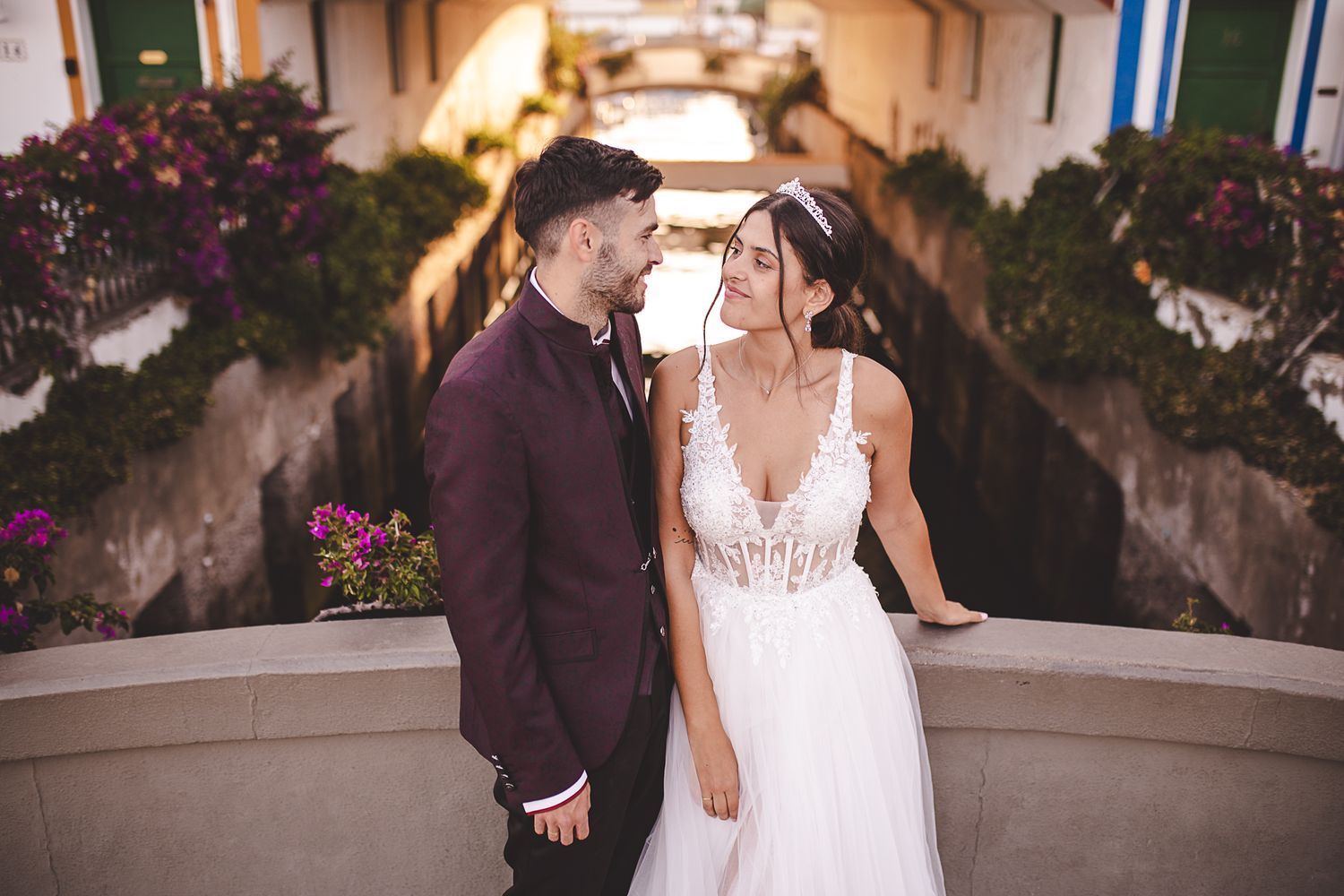 Romantic wedding portraits against a backdrop of blooming flowers and architecture.