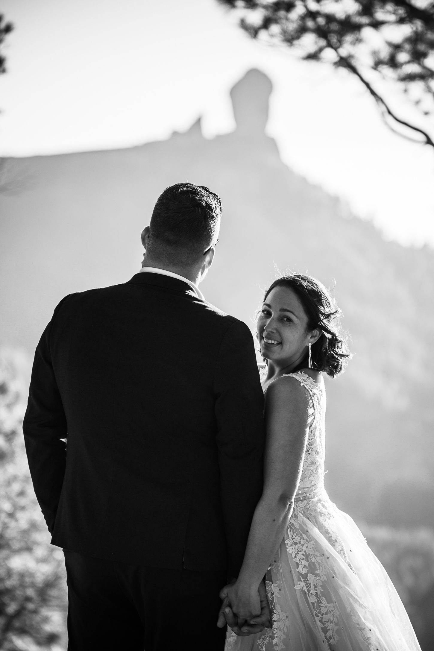 Black and white wedding portraits showing intimate moments between newlyweds in natural outdoor lighting.