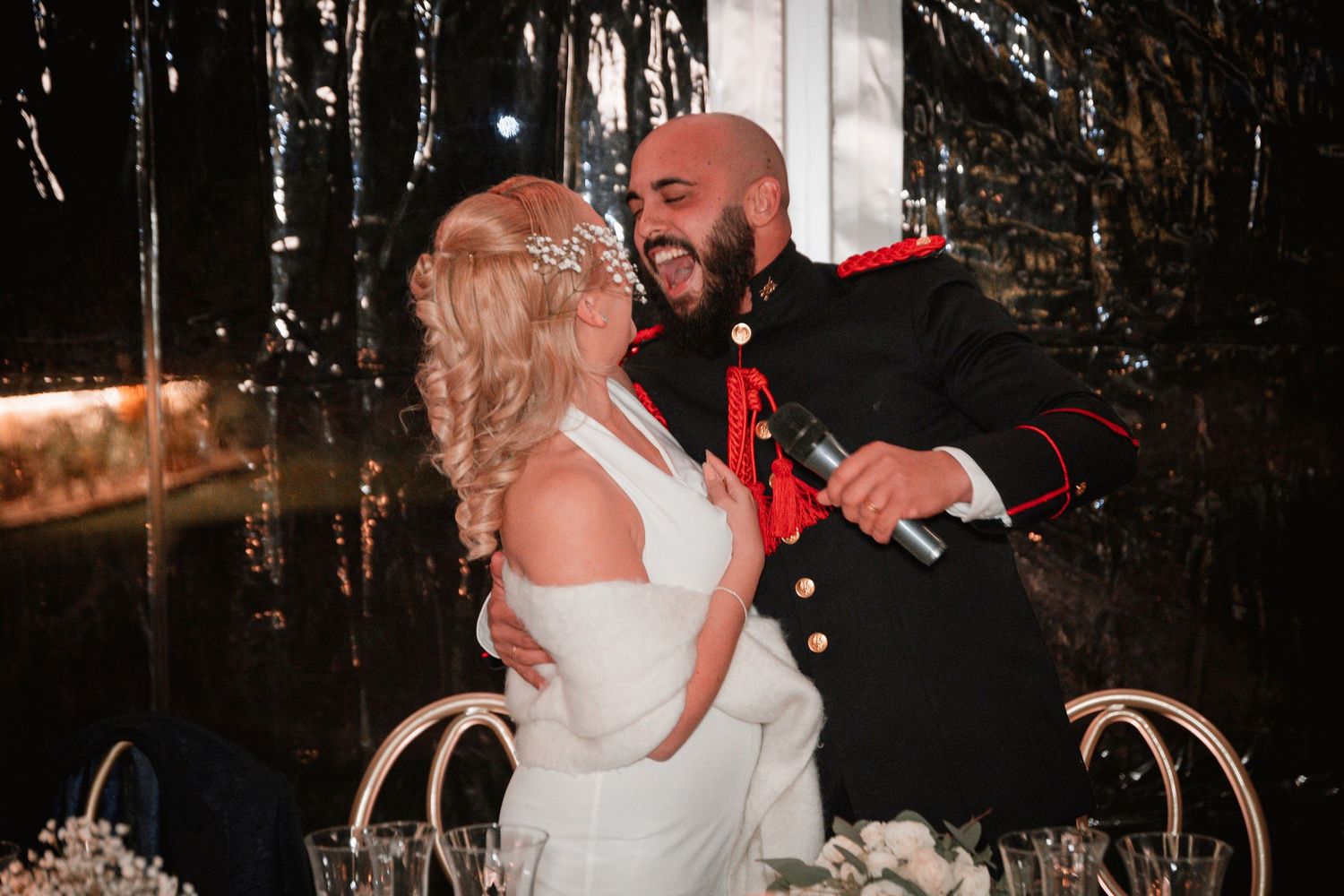A couple sharing a joyful moment during their wedding reception.