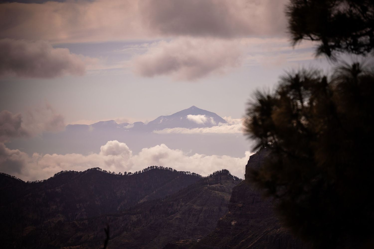 Dramatic mountain landscape with clouds at sunset.