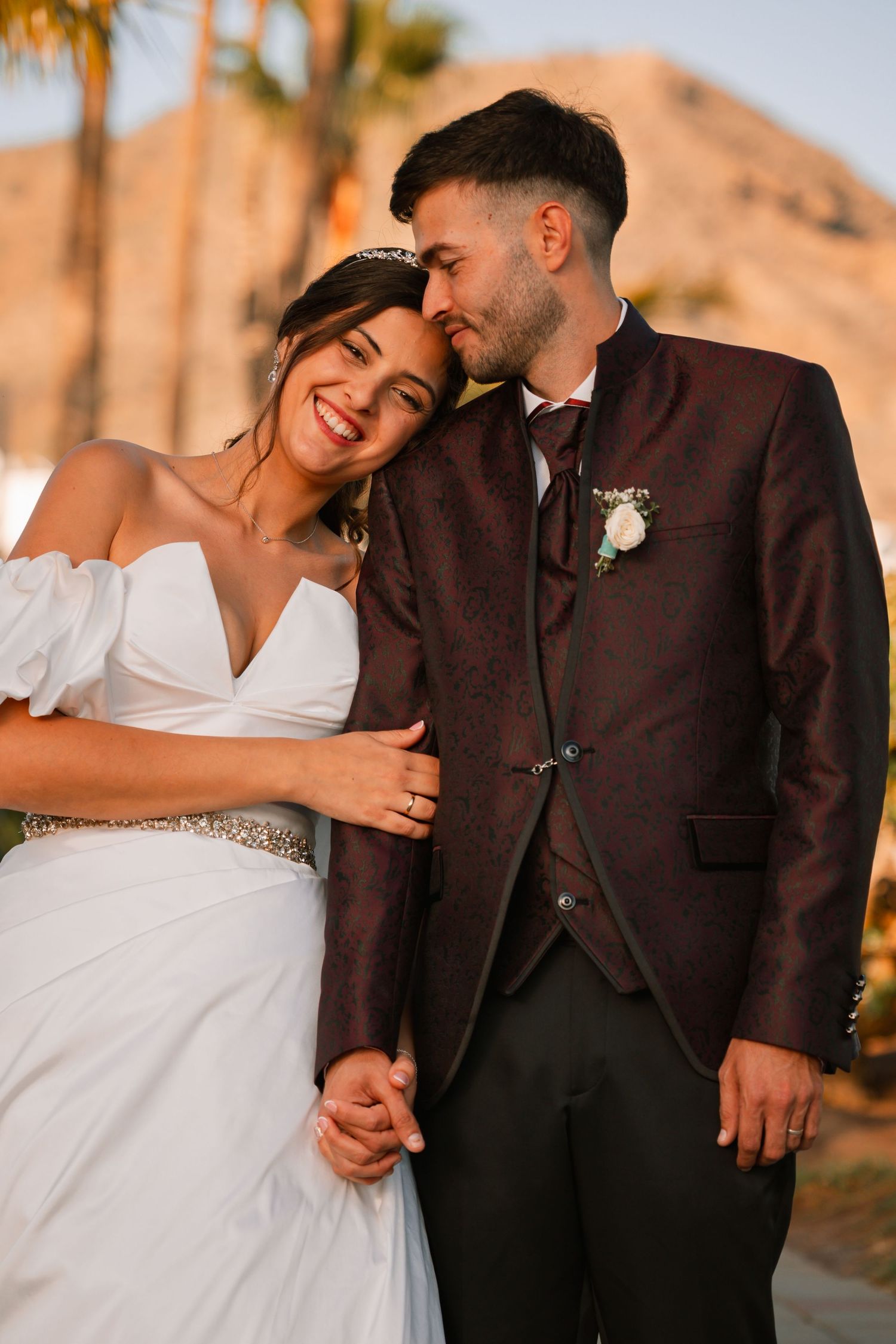 Candid wedding portraits captured at sunset showing tender moments between bride and groom.