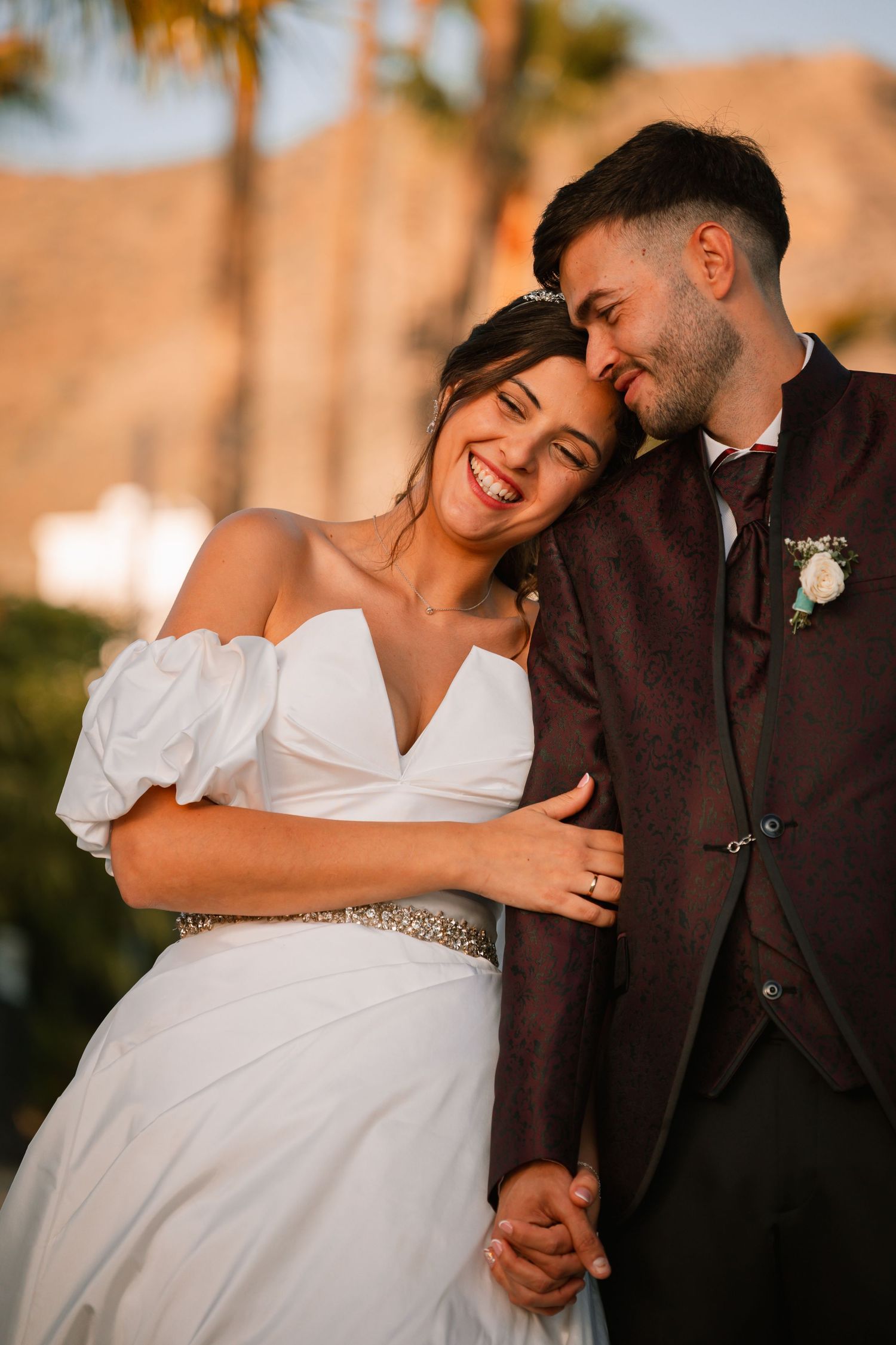 Romantic sunset wedding photoshoot showing intimate moments between newlyweds in formal attire.