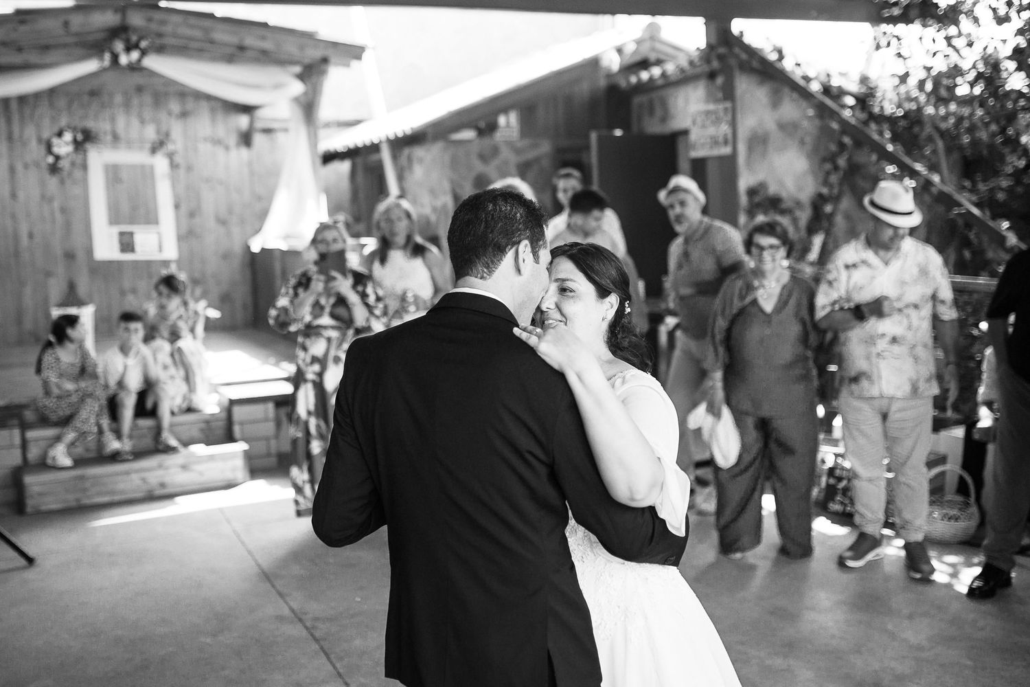 Black and white photos of wedding celebration with guests throwing confetti.