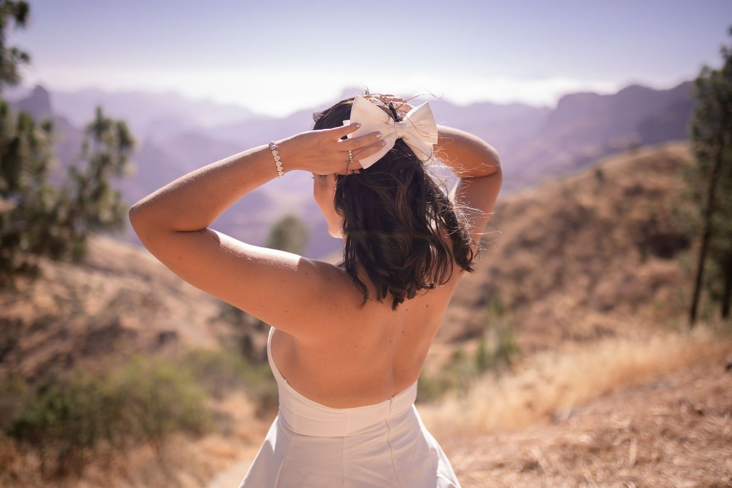 A scenic mountain vista with desert landscape and purple sky.