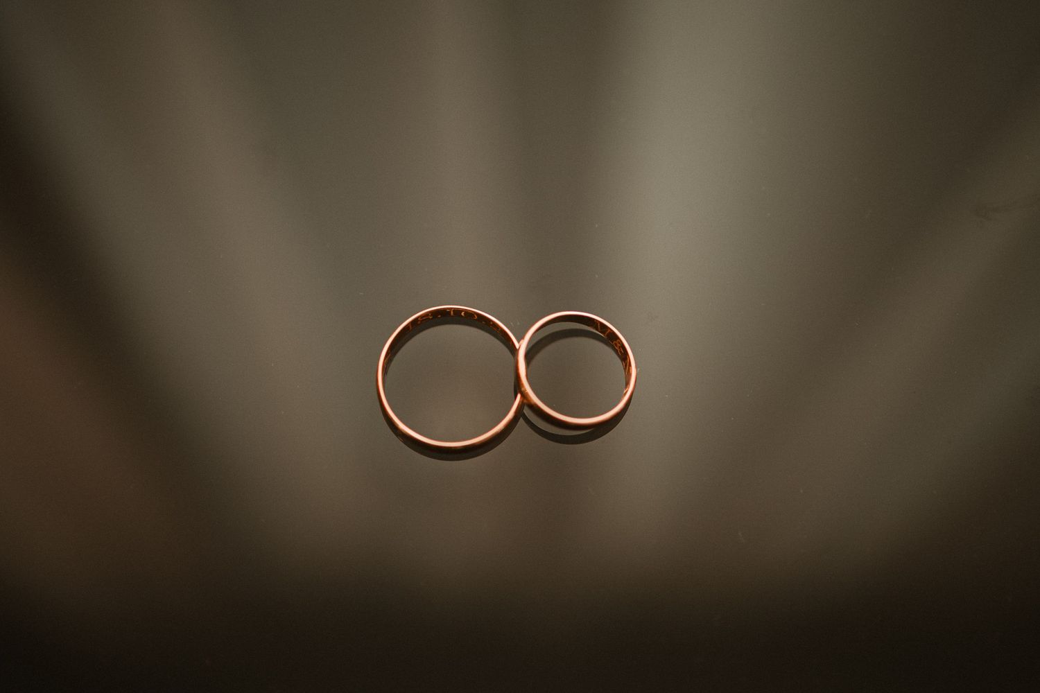 Artistic macro shot of wedding rings with shallow depth of field.