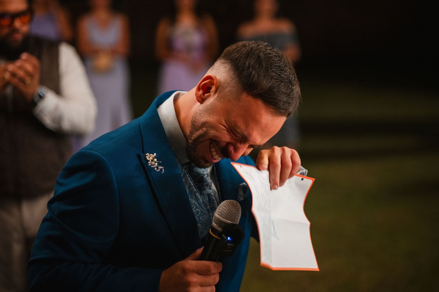Emotional wedding speech delivered during outdoor evening reception.