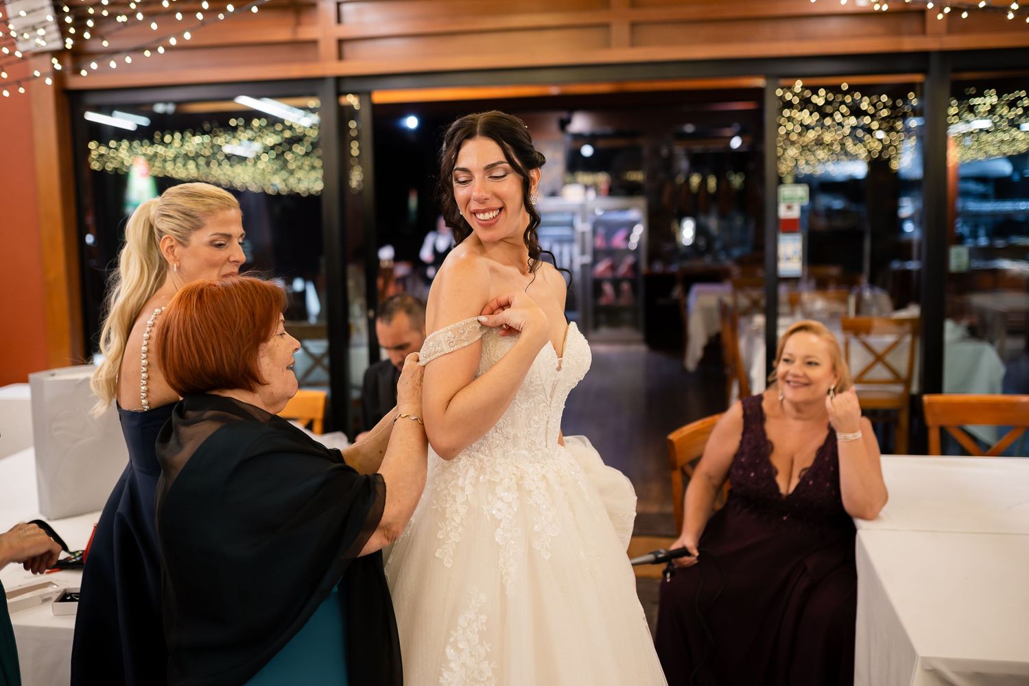 Wedding reception venue decorated with warm lighting and elegant table settings.