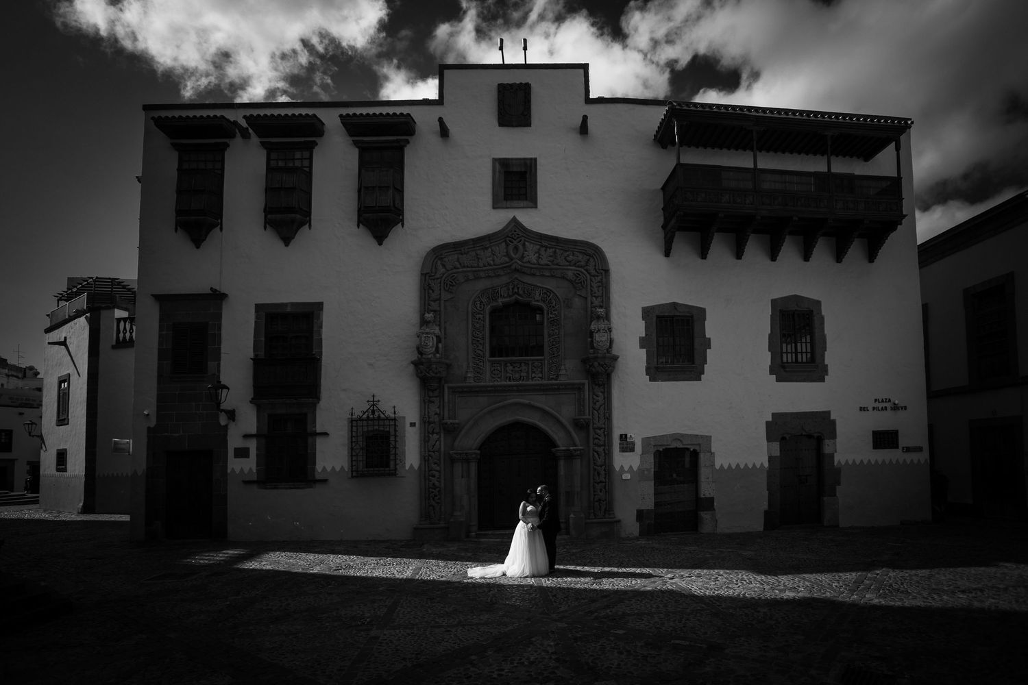 Dramatic black and white architectural wedding venue with historic Spanish colonial details.