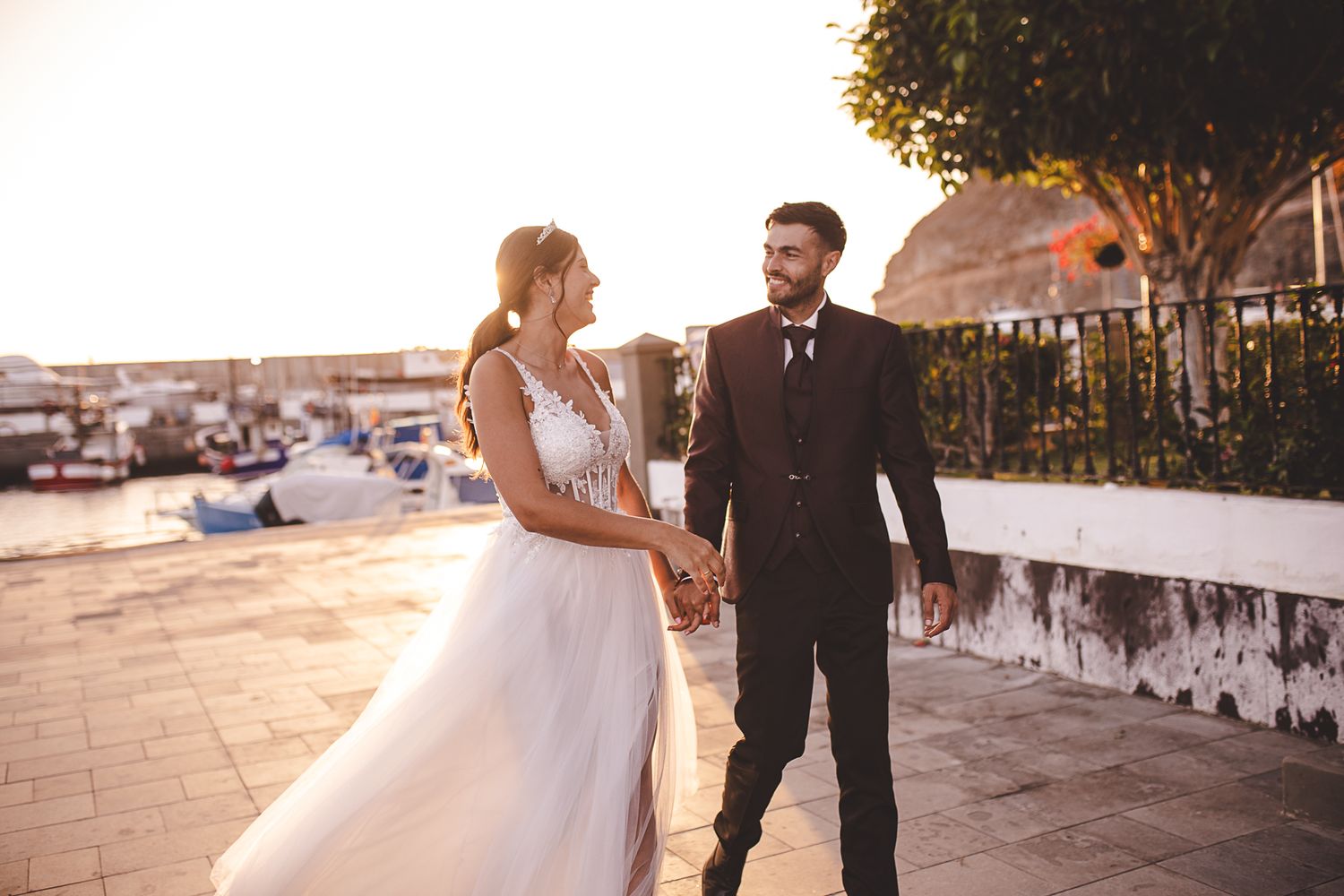 Sunset wedding portraits captured along a coastal promenade.