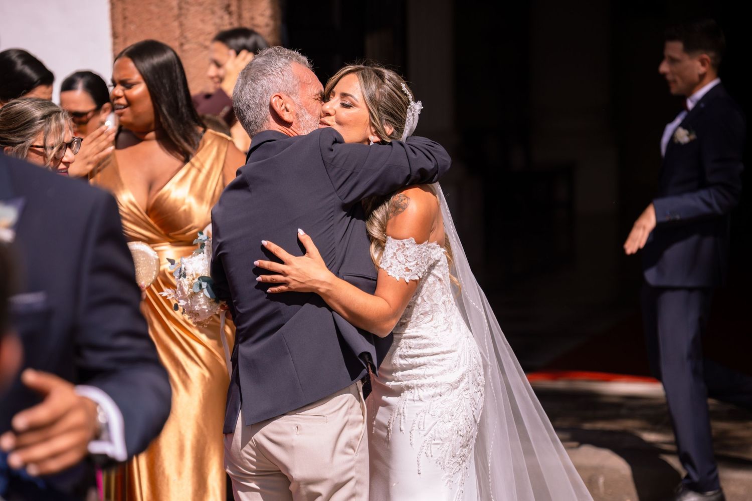 Joyful wedding celebration with couples dancing and embracing on the dance floor.