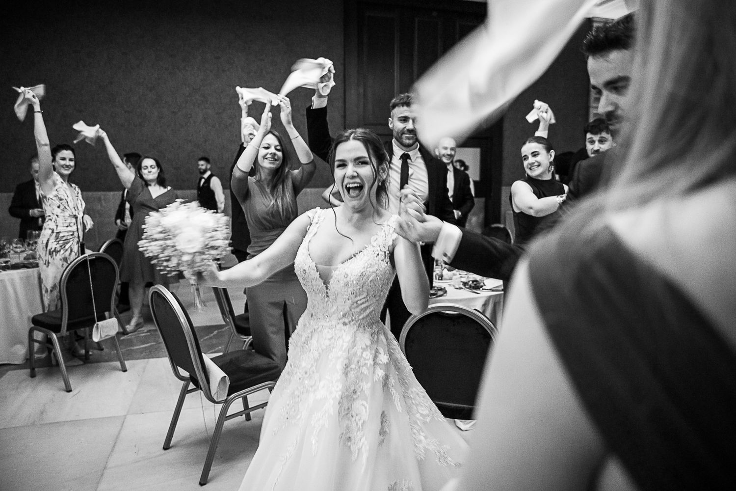 Wedding reception dance party with guests celebrating on the dance floor.