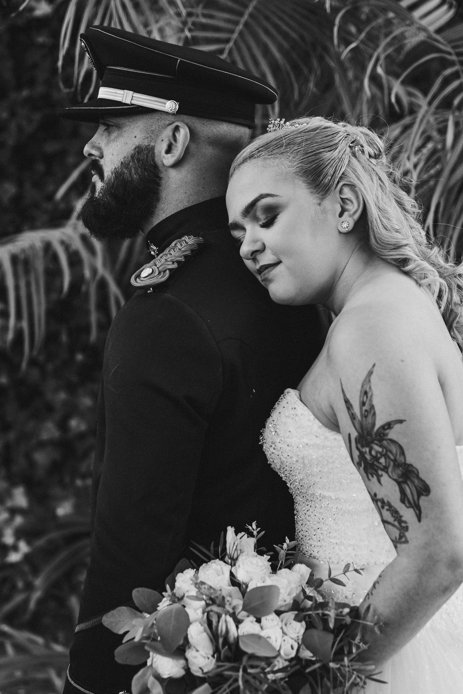 A romantic black and white wedding photo series showing tender moments between newlyweds with a bridal bouquet.