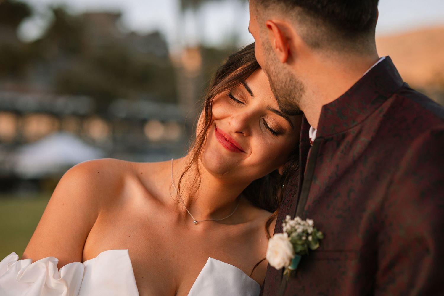 Close-up wedding photos showing intimate moments between newlyweds at sunset.
