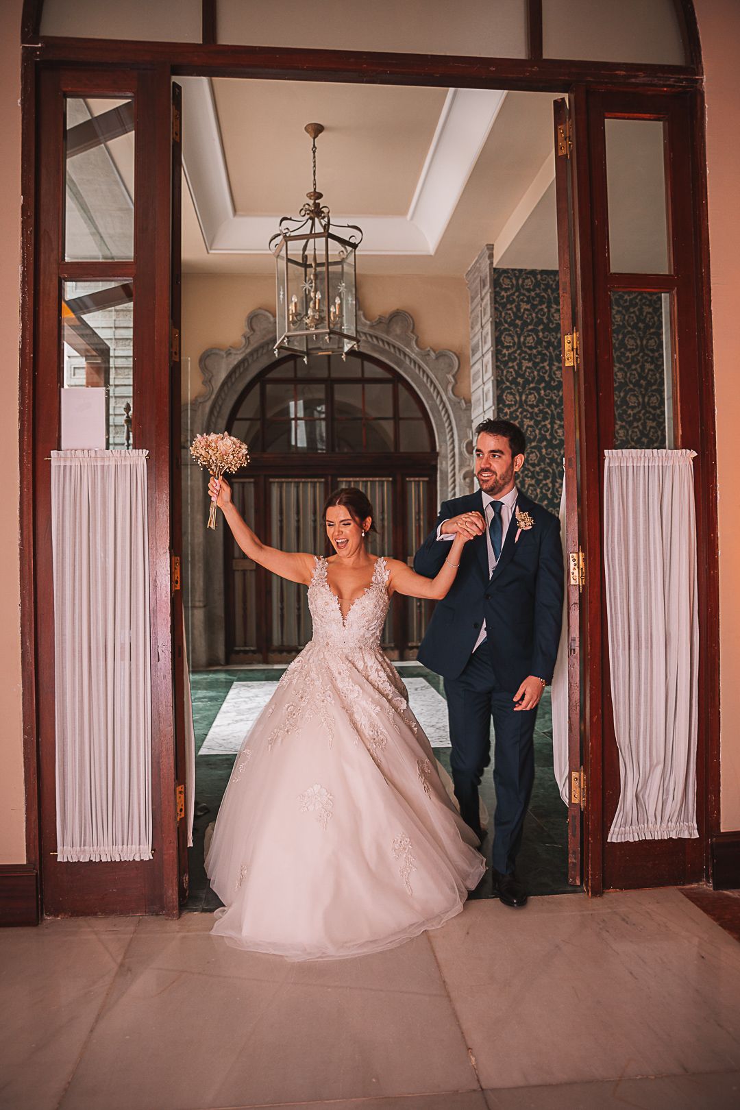 Elegant wedding dance sequence in a grand ballroom with ornate architectural details.