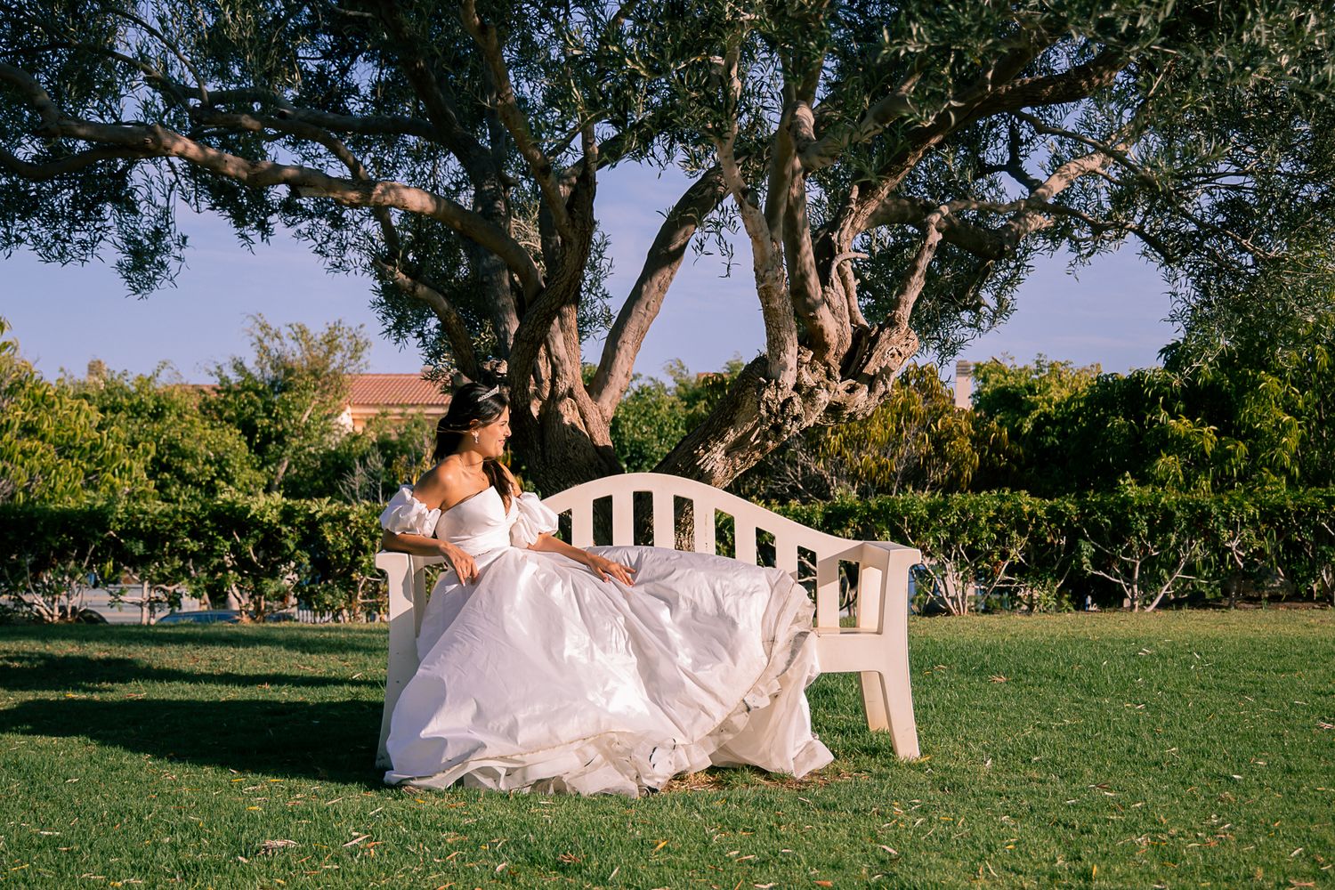 Wedding couple posing in various romantic shots on a grassy hillside.