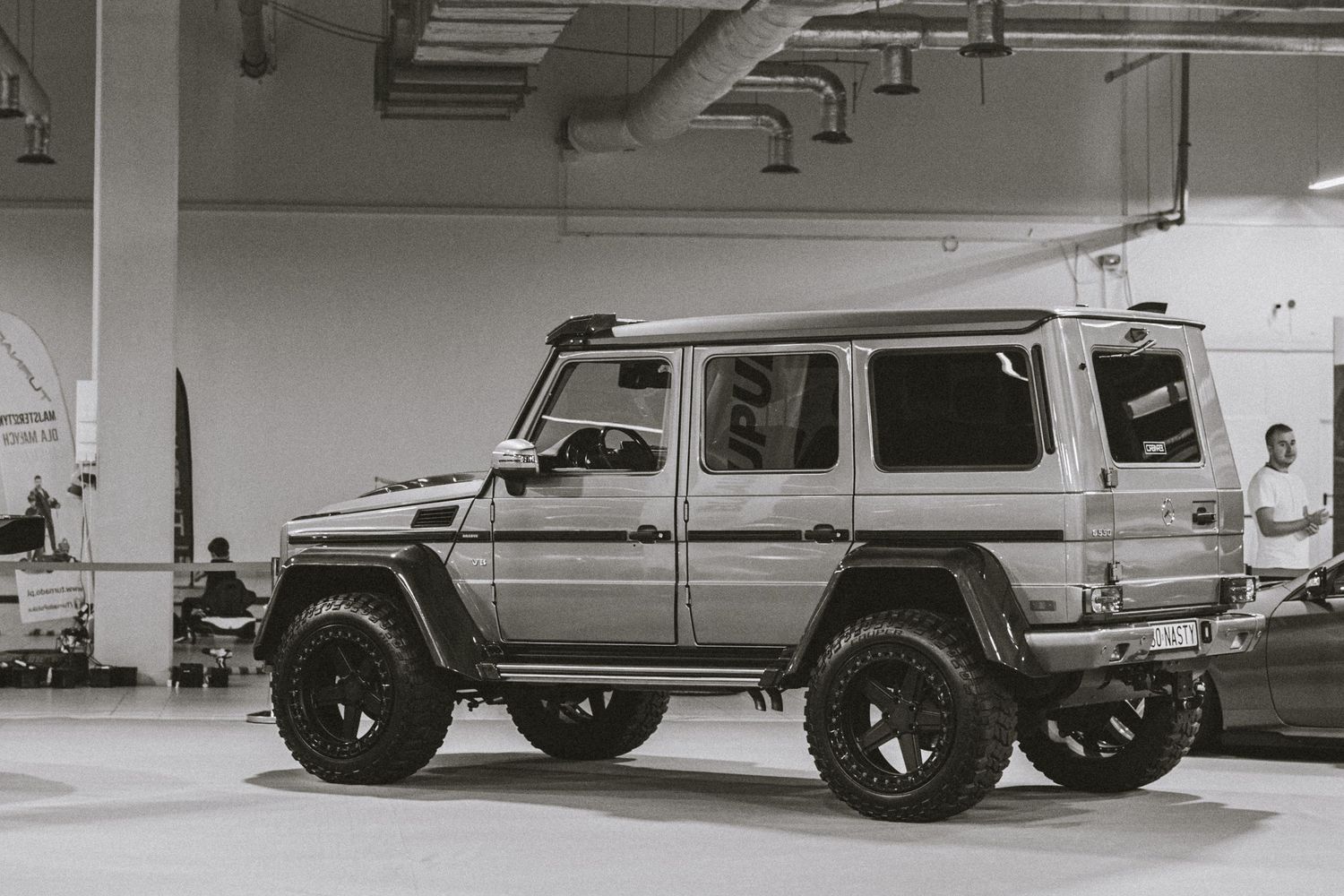 Row of luxury SUVs and performance vehicles displayed in a bright indoor showroom.