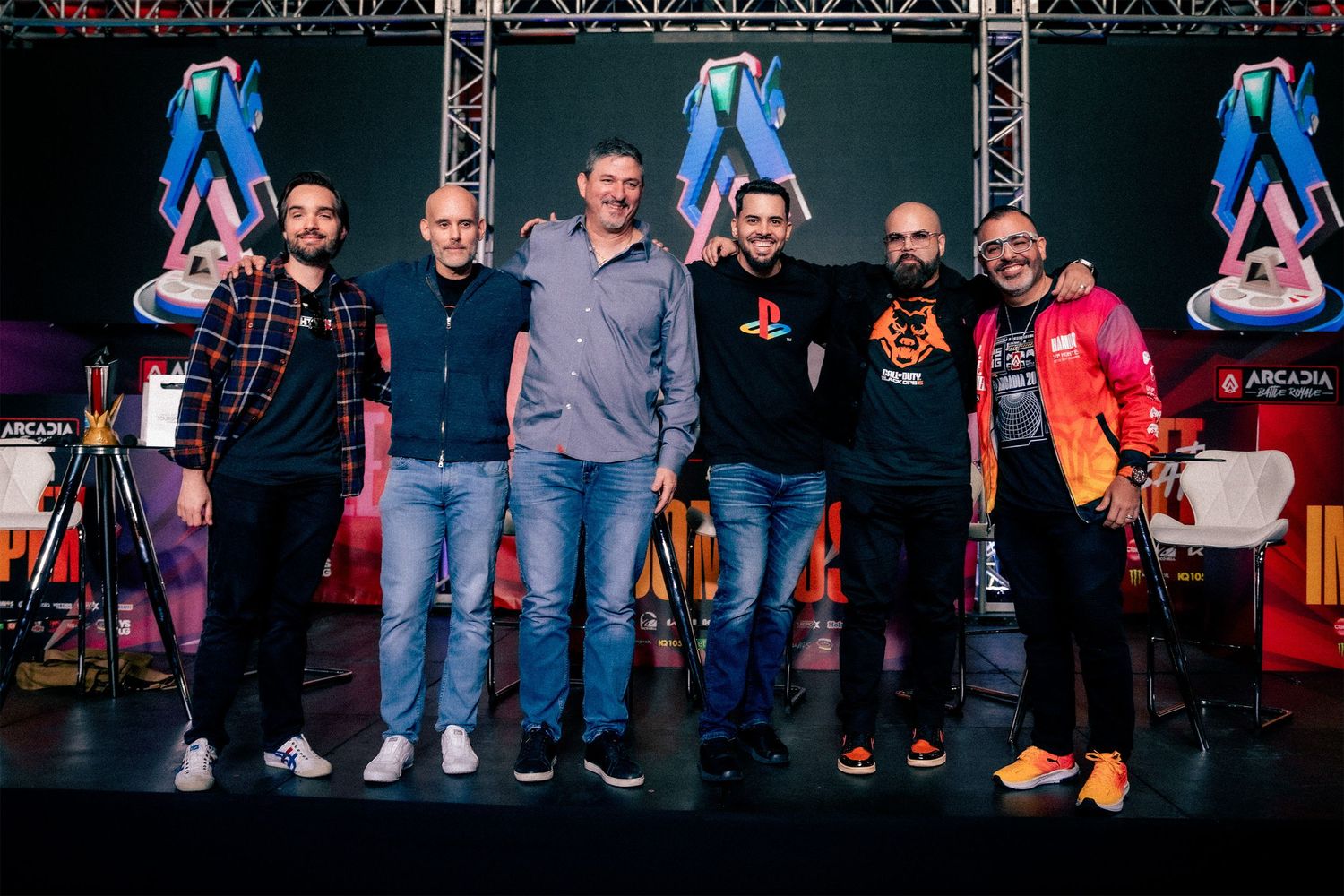 Competitors lined up on stage at gaming tournament with event lighting and production setup.