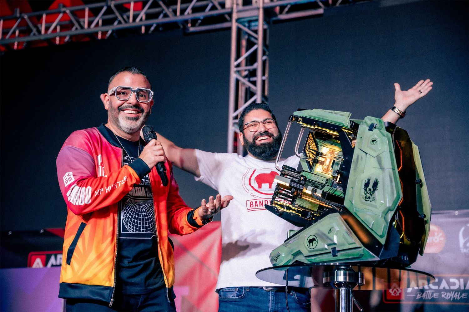 Event performers on stage with PC equipment during a live show.