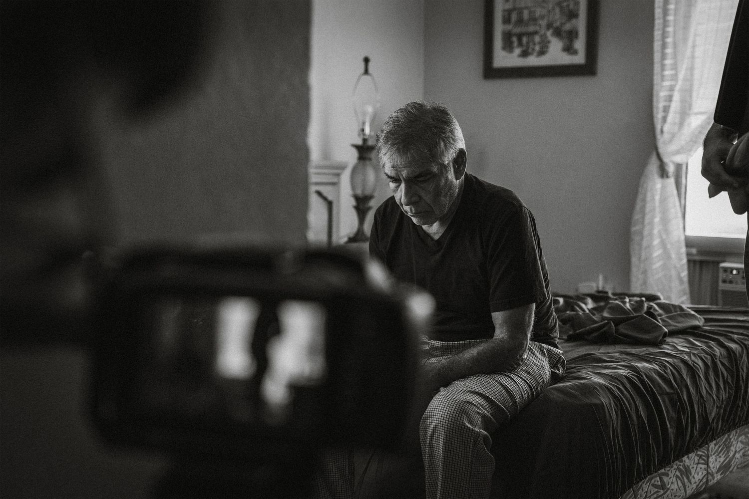 Black and white interior scene with soft window lighting in a quiet room.