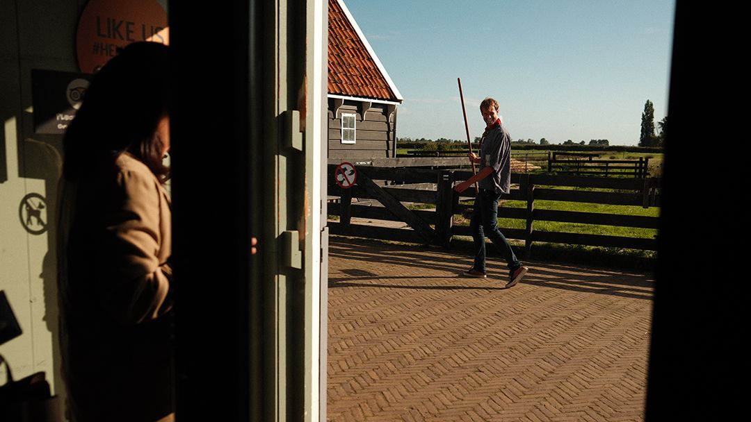 Series of doorway frames creating a perspective view down a brick-paved path.