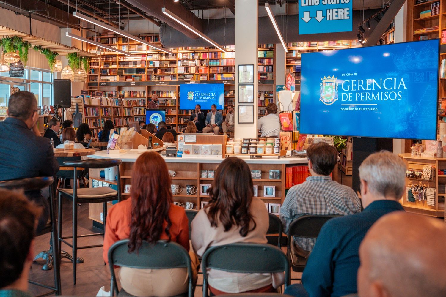 Interior of modern bookstore with rows of shelves and digital displays.