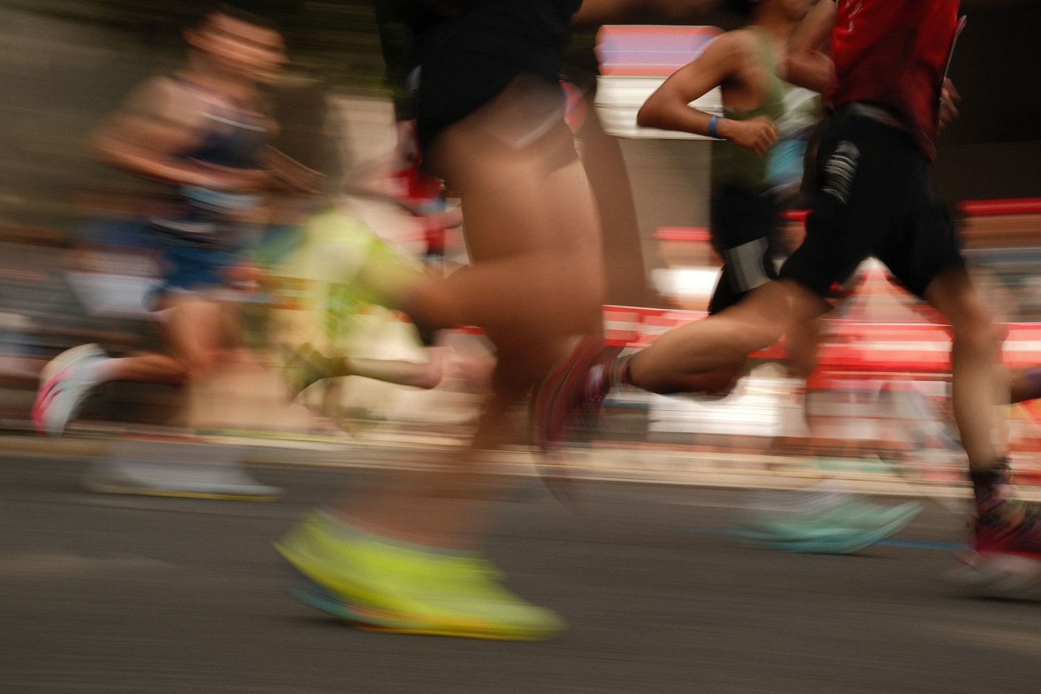 Blurred motion shot of runners' feet during a marathon race.