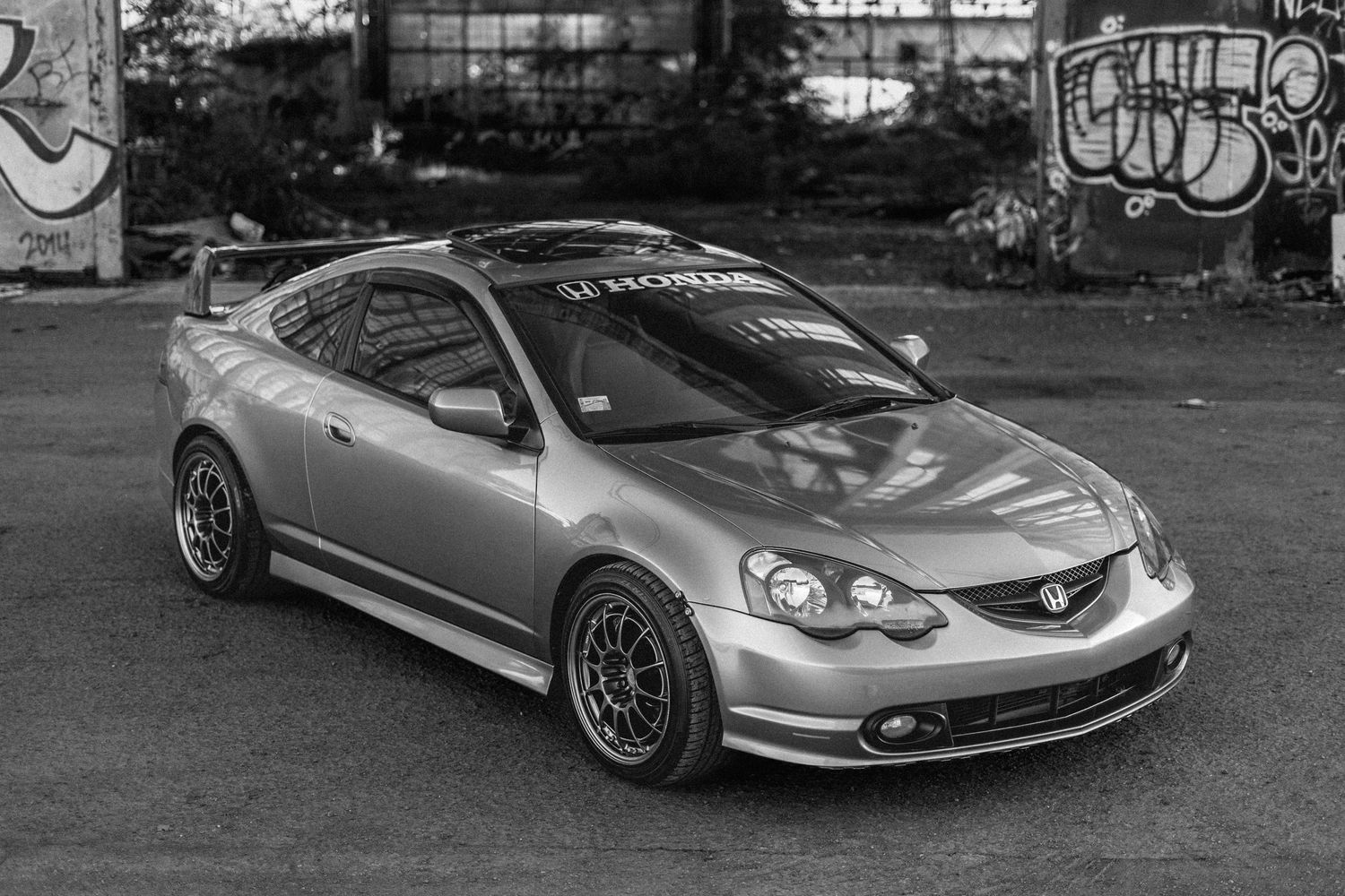 Collection of modified sports cars and luxury vehicles photographed in various outdoor settings.
