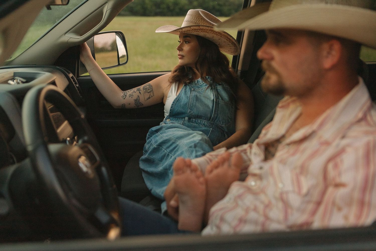 A western vibe couple posing in a truck in Caddo Mills, Texas