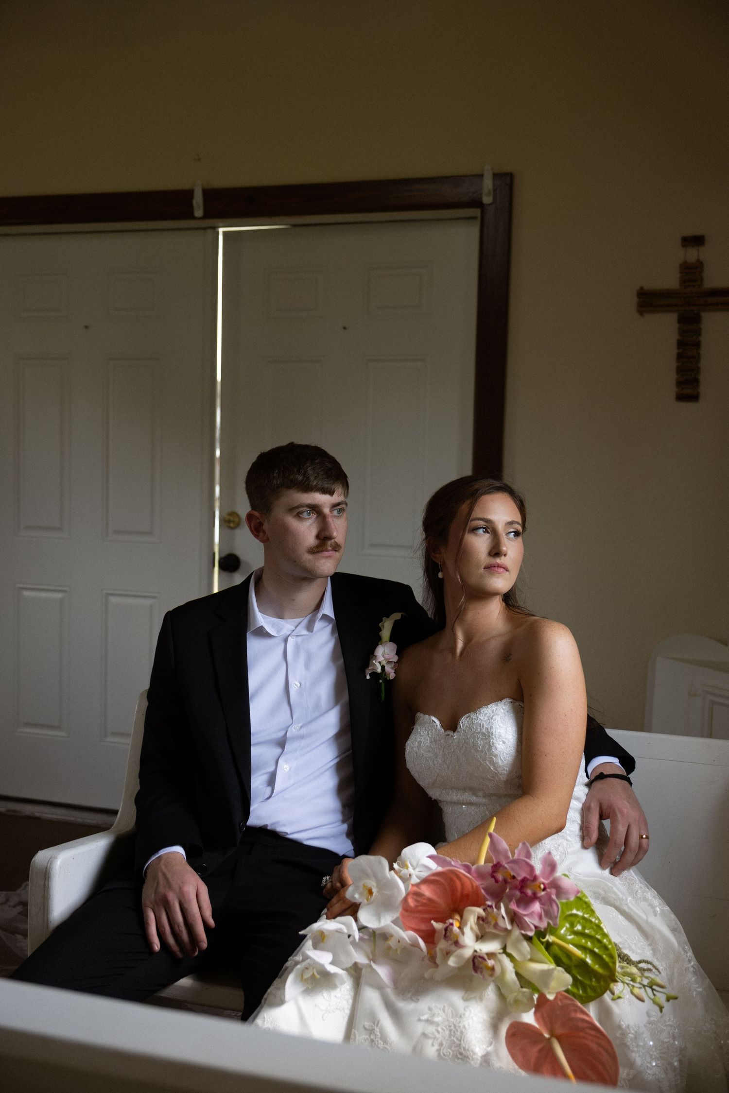 A couple in wedding attire sits together on a couch in a sequence of intimate candid moments.