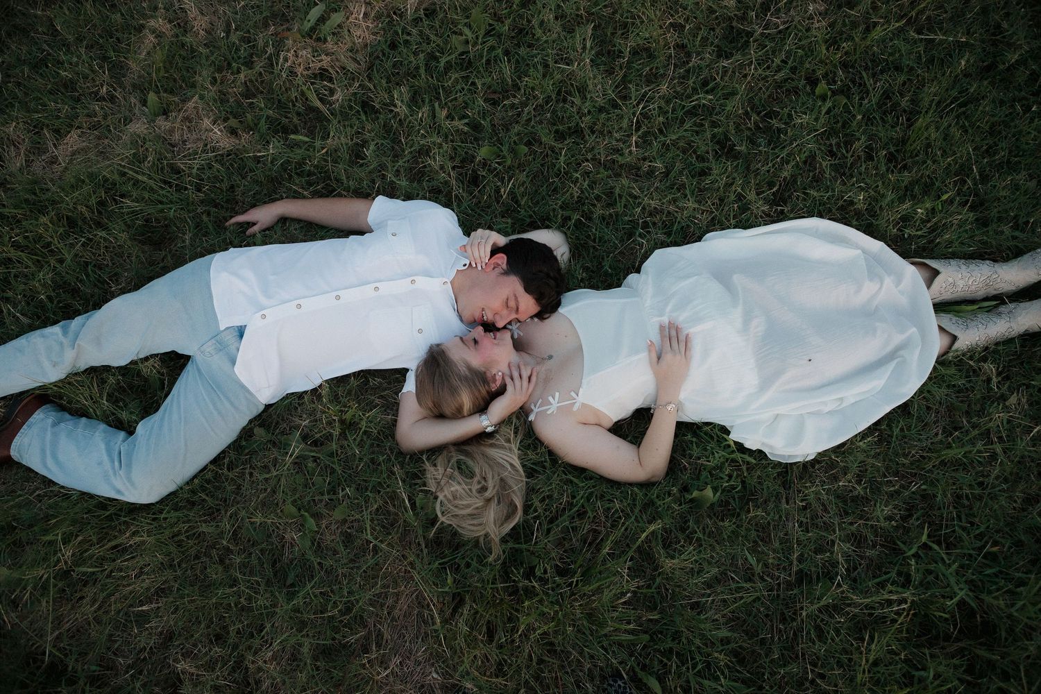 A western couple candidly laying in the grass in Caddo Mills, Texas