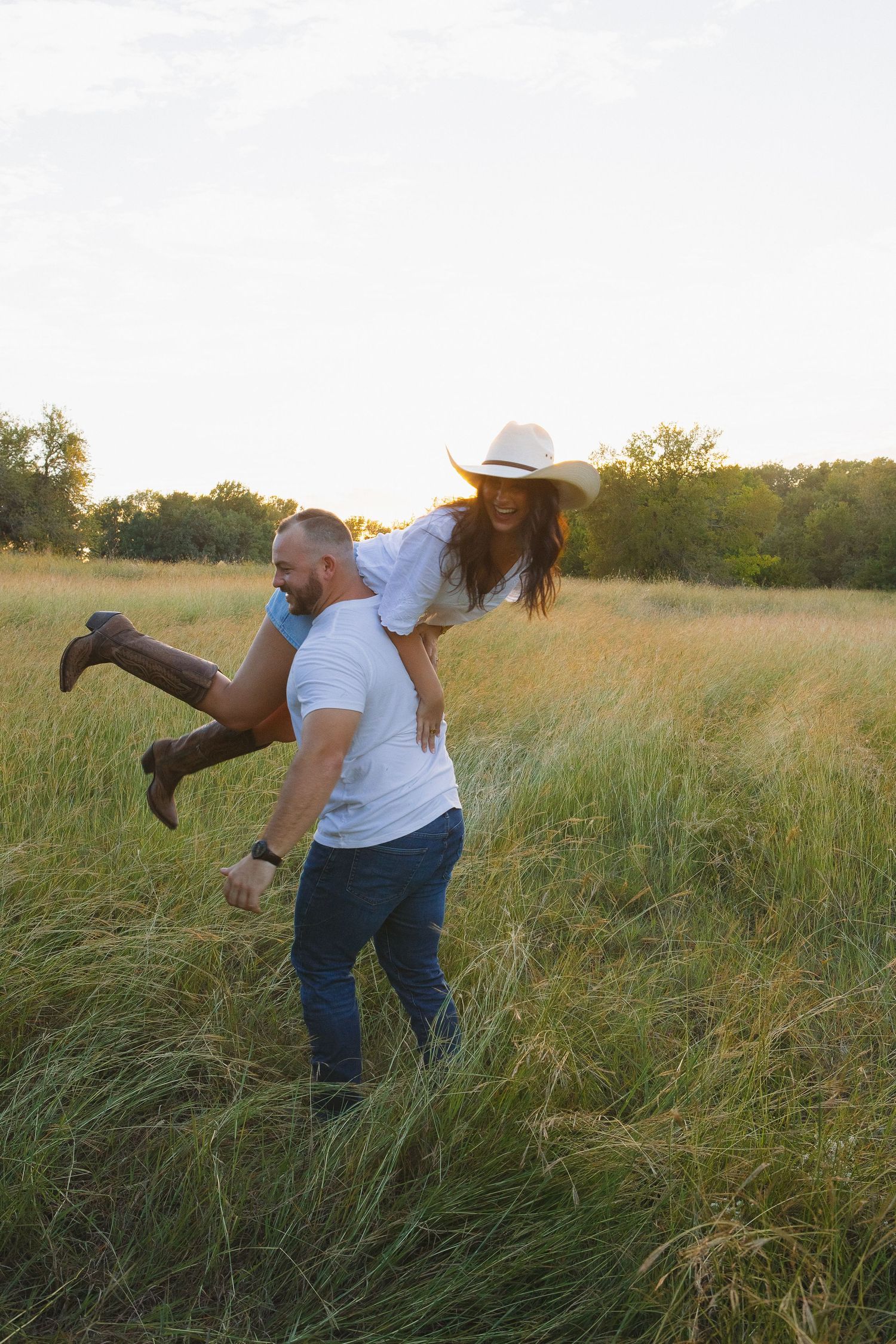 A playful photoshoot sequence in a grassy field at sunset with someone wearing a white shirt and cowboy hat.