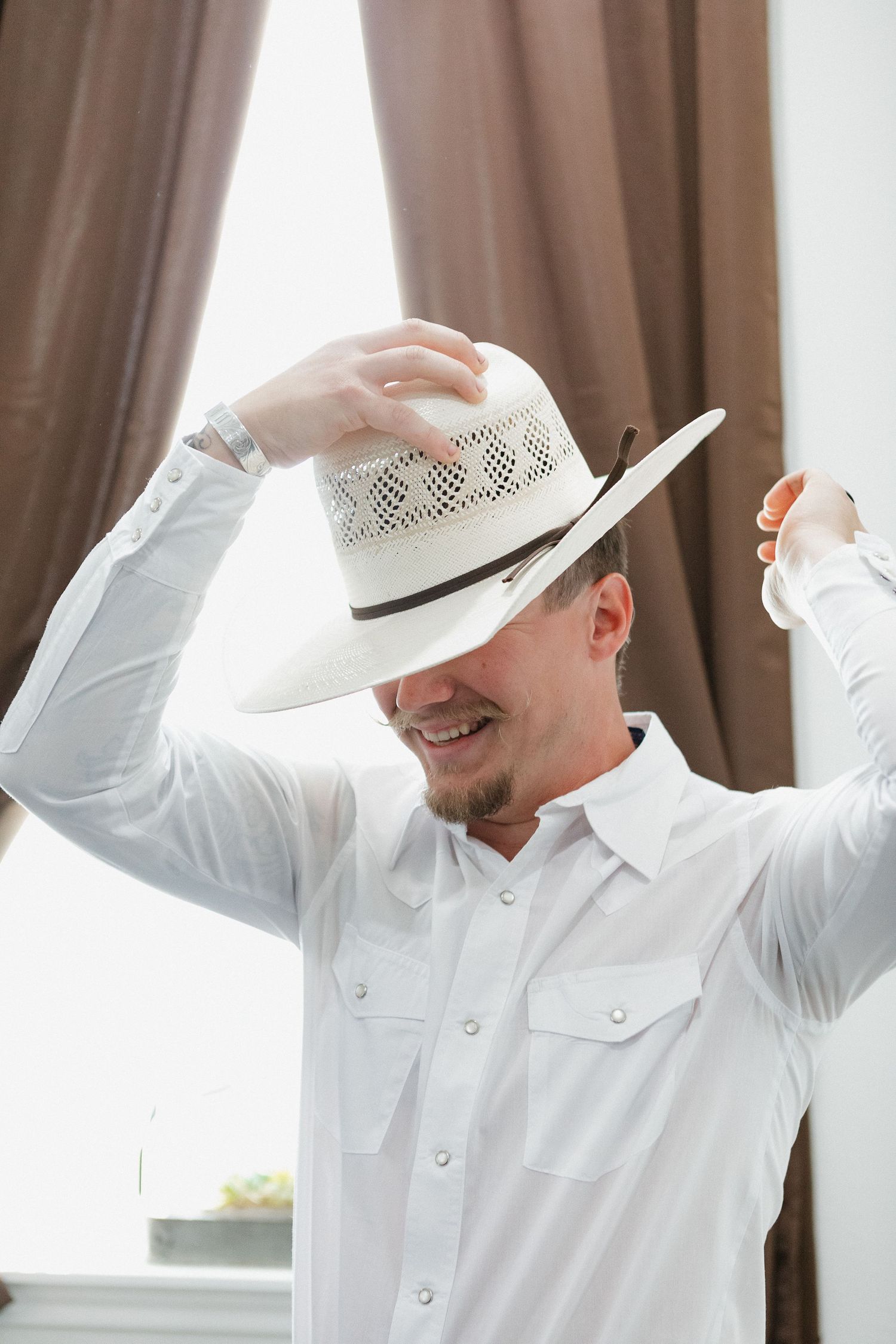 Person in white western attire and cowboy hat striking playful poses in a sequence of indoor photos.