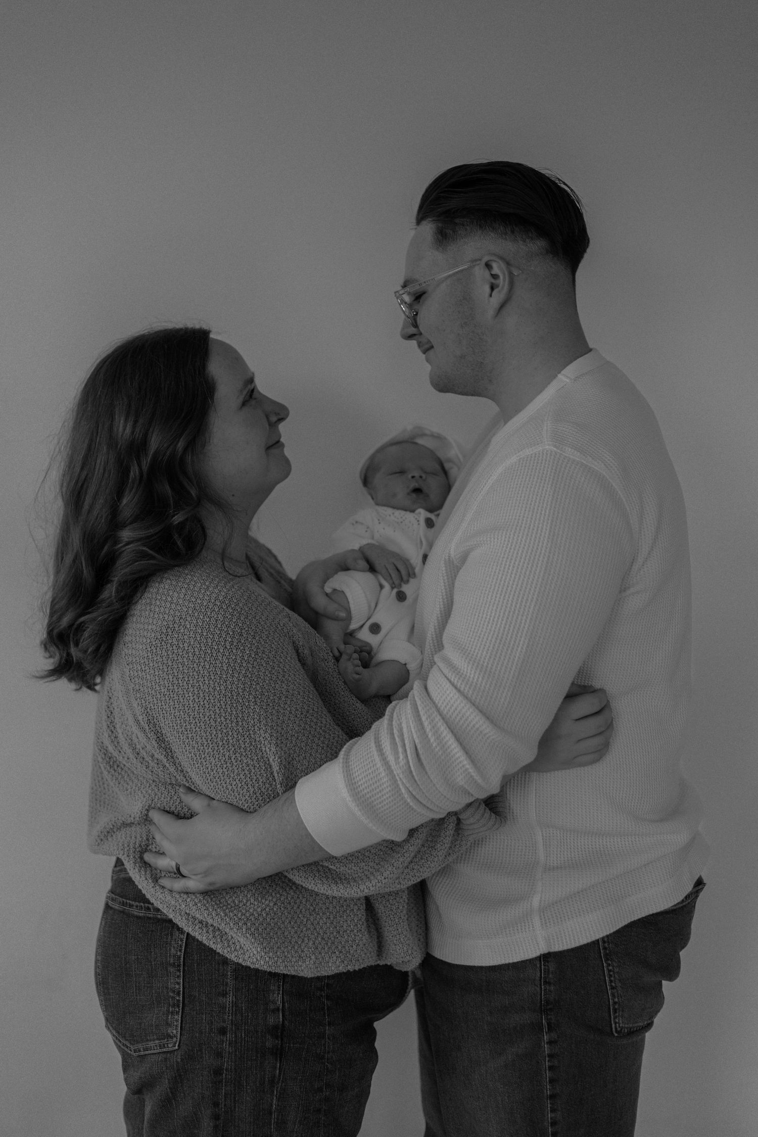 A series of black and white photos showing a couple embracing and sharing intimate moments together.