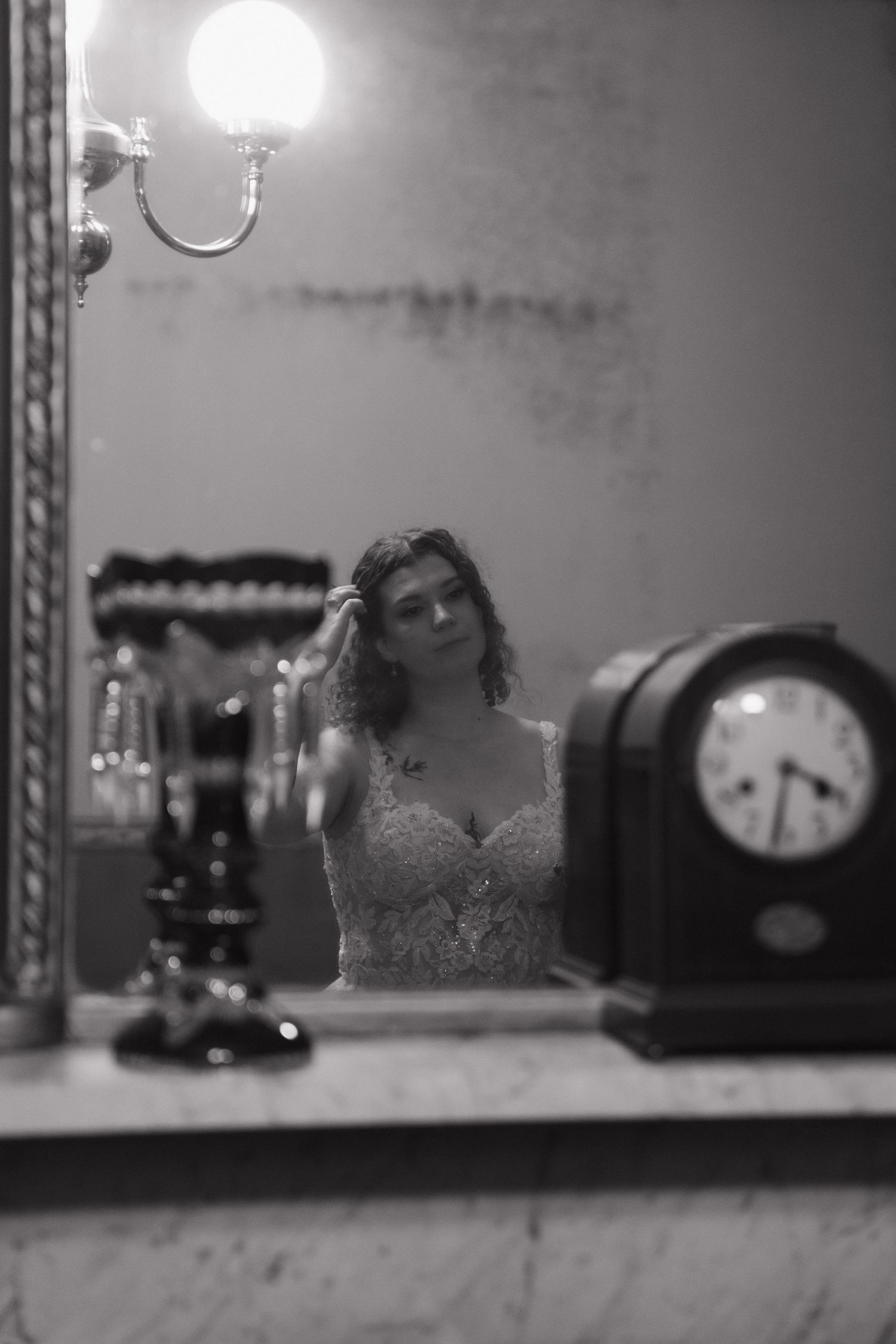 Vintage clocks and decorative items displayed on a shelf in black and white.