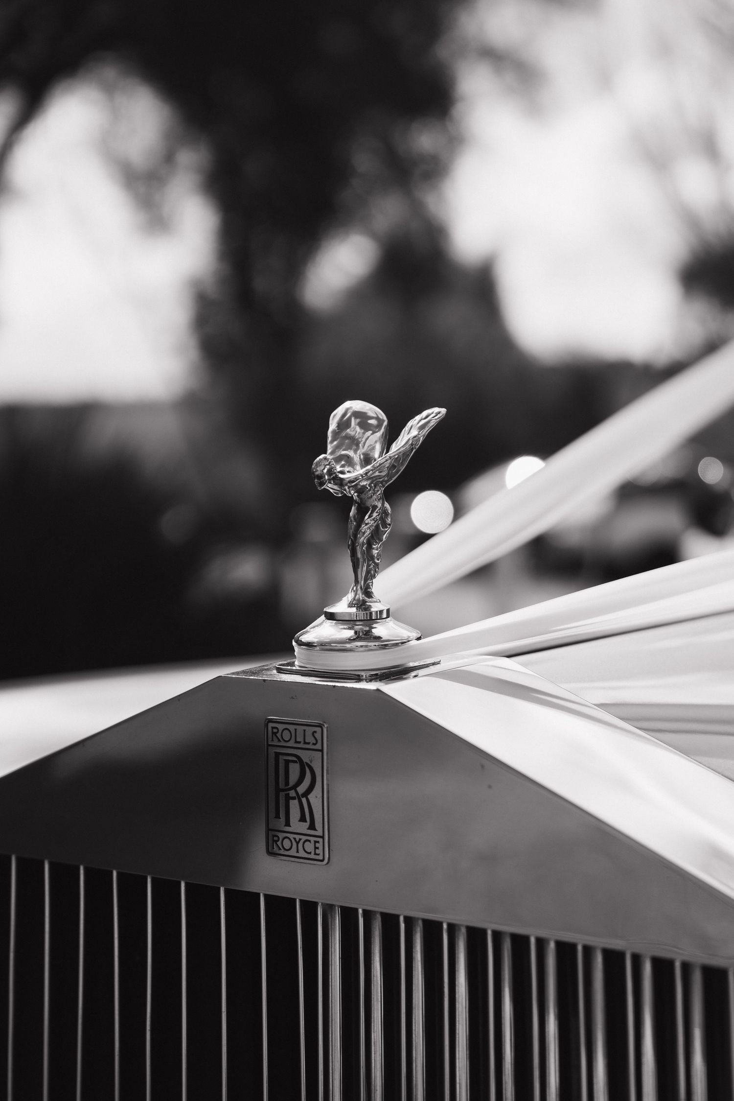 Classic Rolls Royce hood ornament detail in black and white.