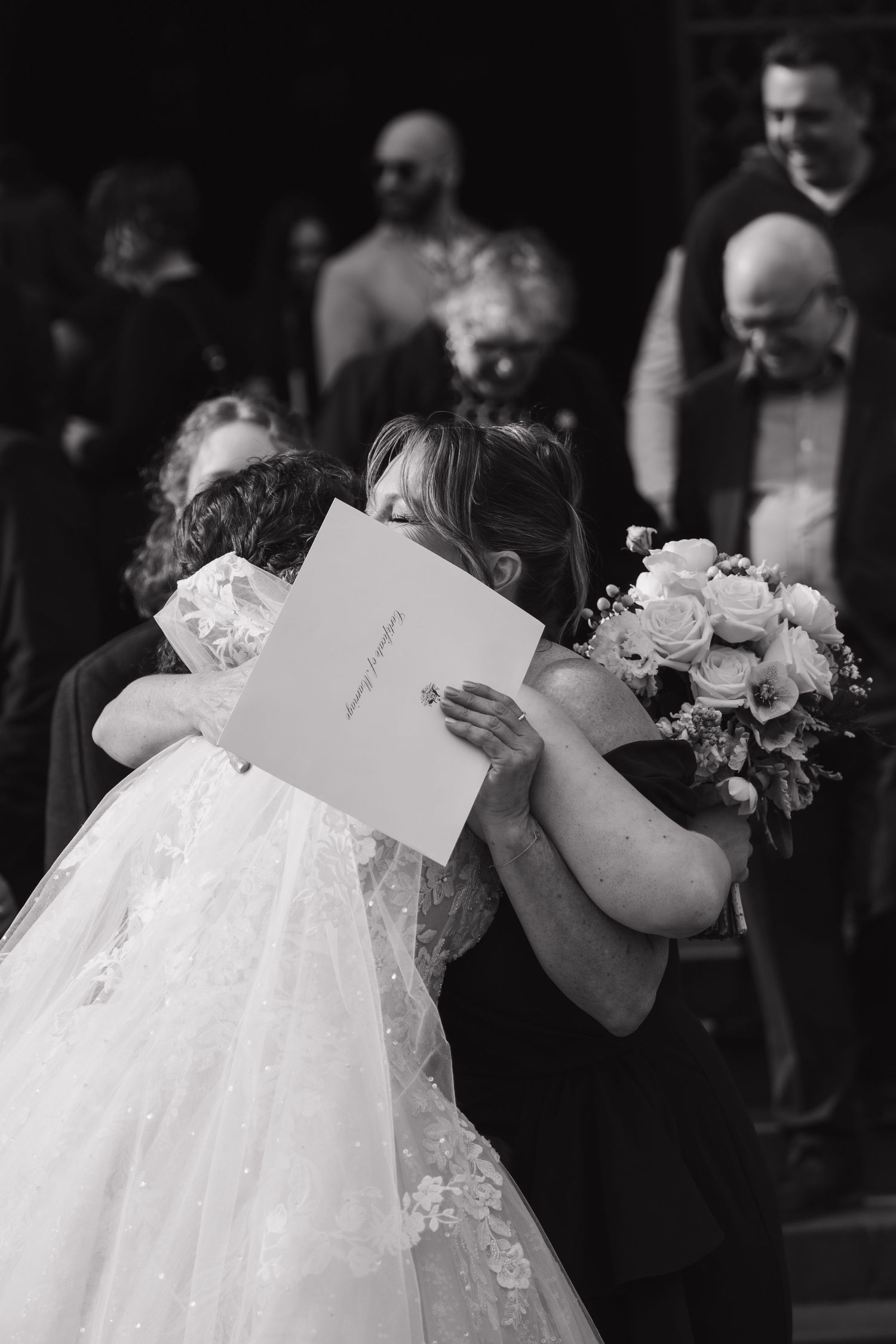 Black and white sequence of a bride holding wedding cards during the ceremony.