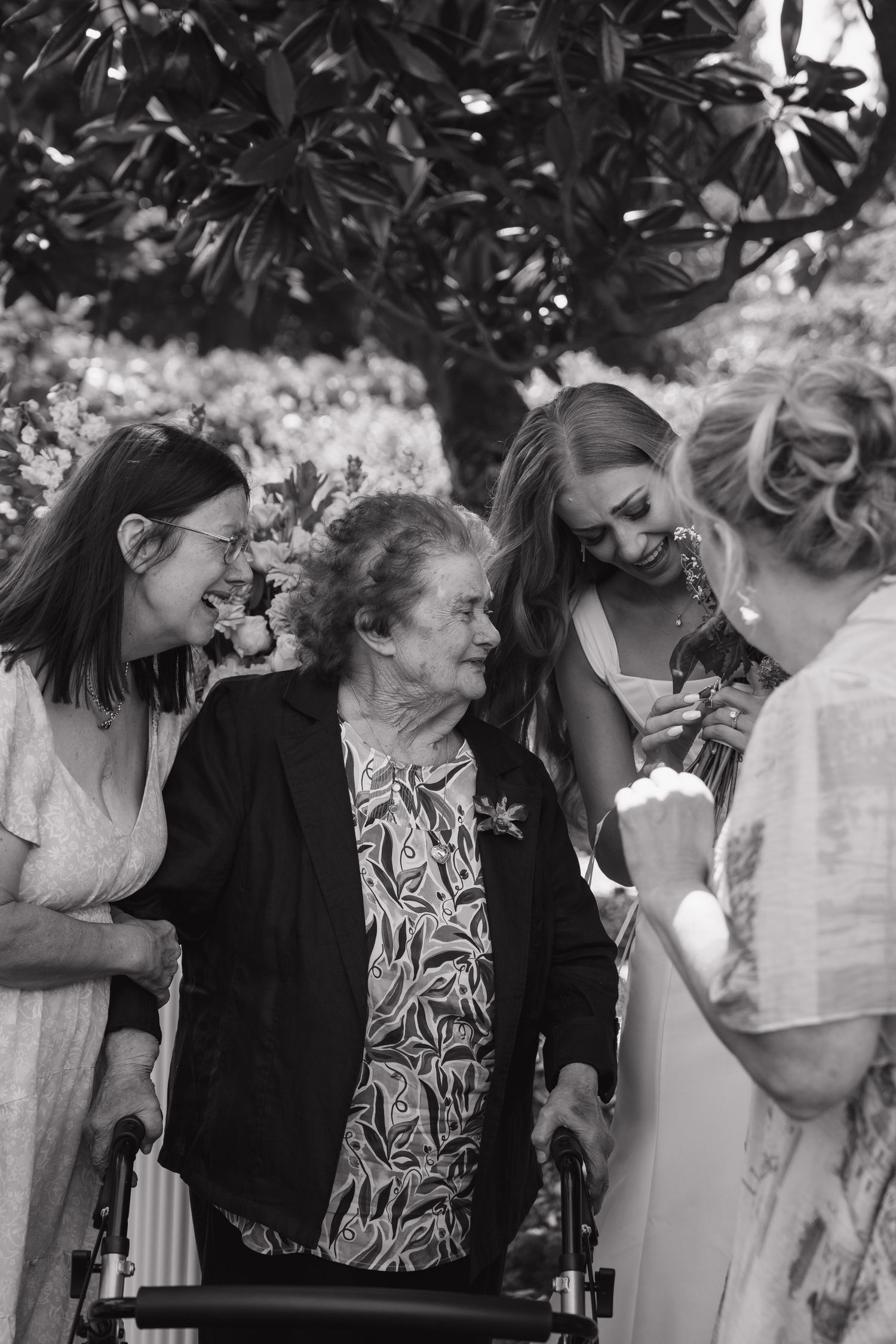 Black and white wedding photo sequence showing an intimate kiss moment in a garden setting.