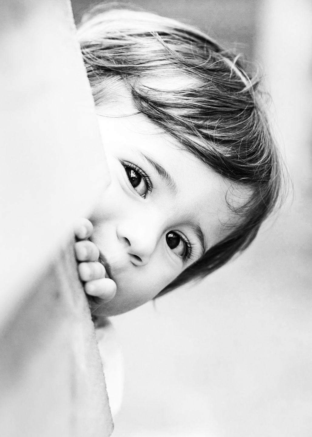 A black and white artistic portrait composition showing four cropped facial close-ups in a row.