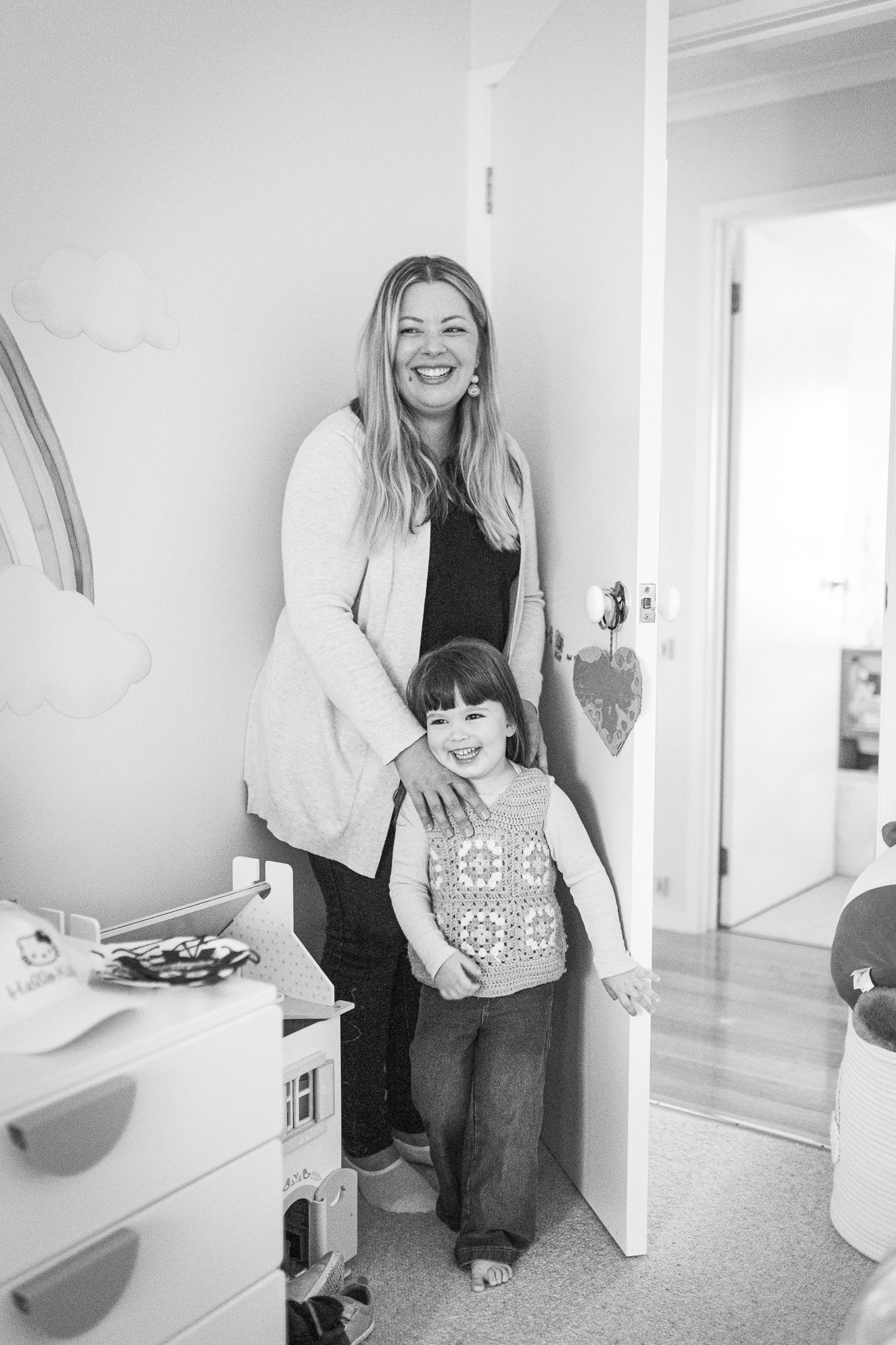 Black and white image of mother and daughter smiling.