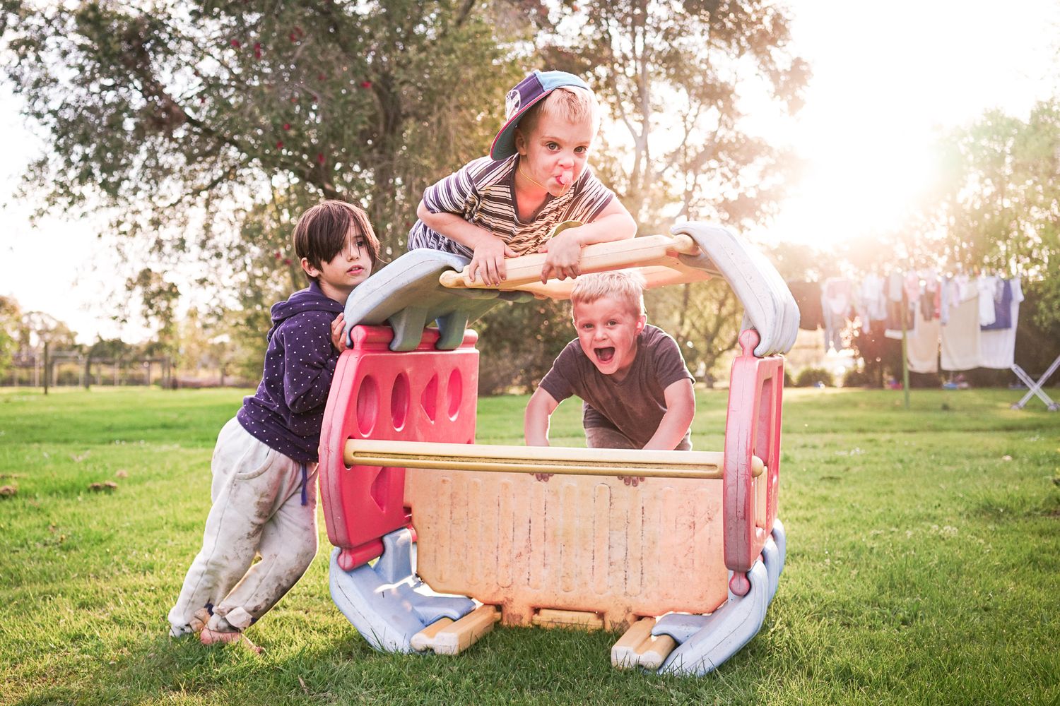 A group of people enjoy a picnic and play together in a sunny park setting during a warm afternoon.